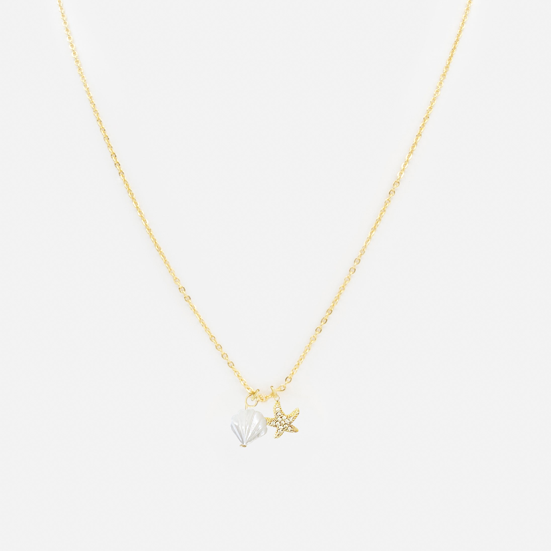 Gold necklace with shell and starfish charms