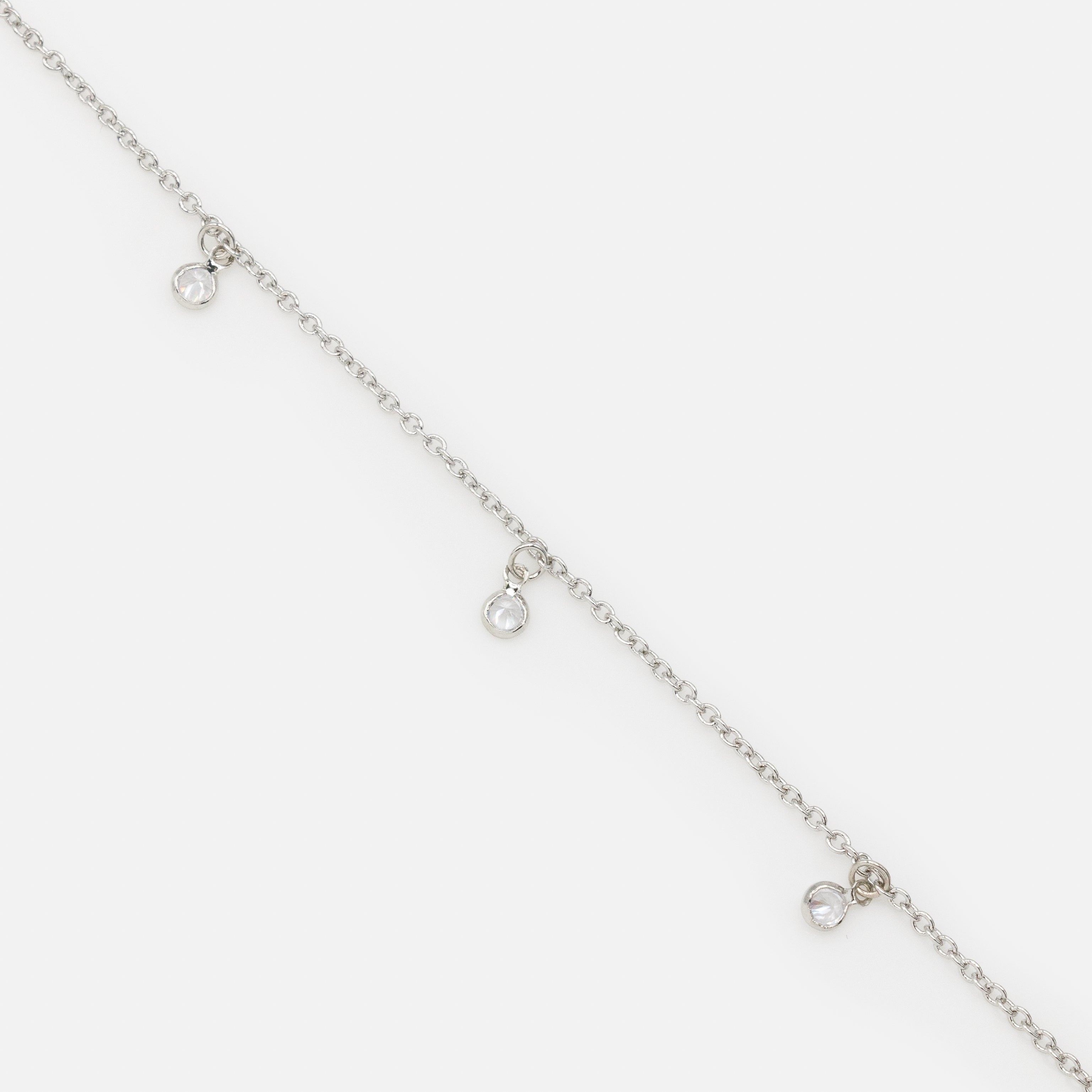 Silver bracelet with small round charms and cubic zirconia