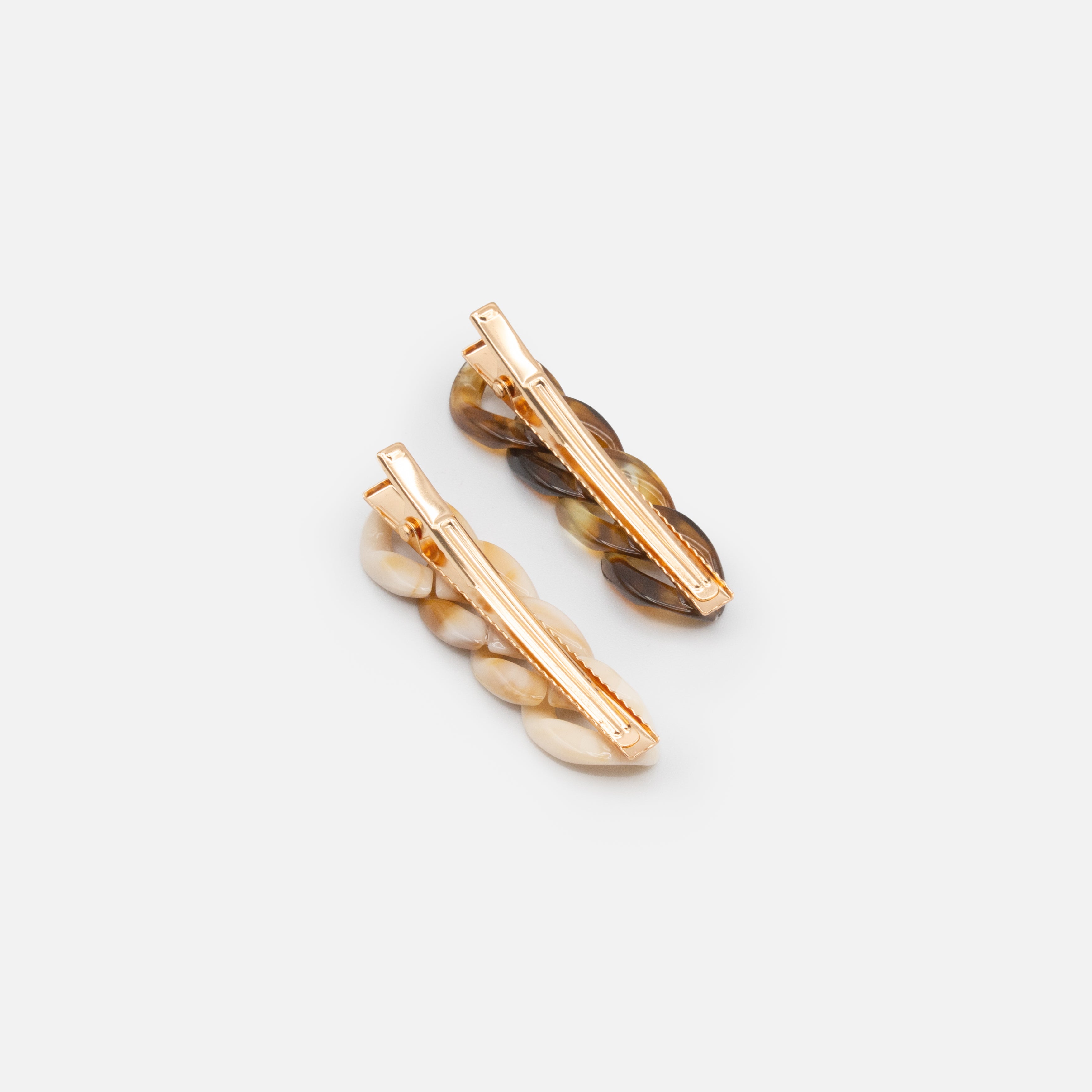 Duo of ivory and tortoise clips