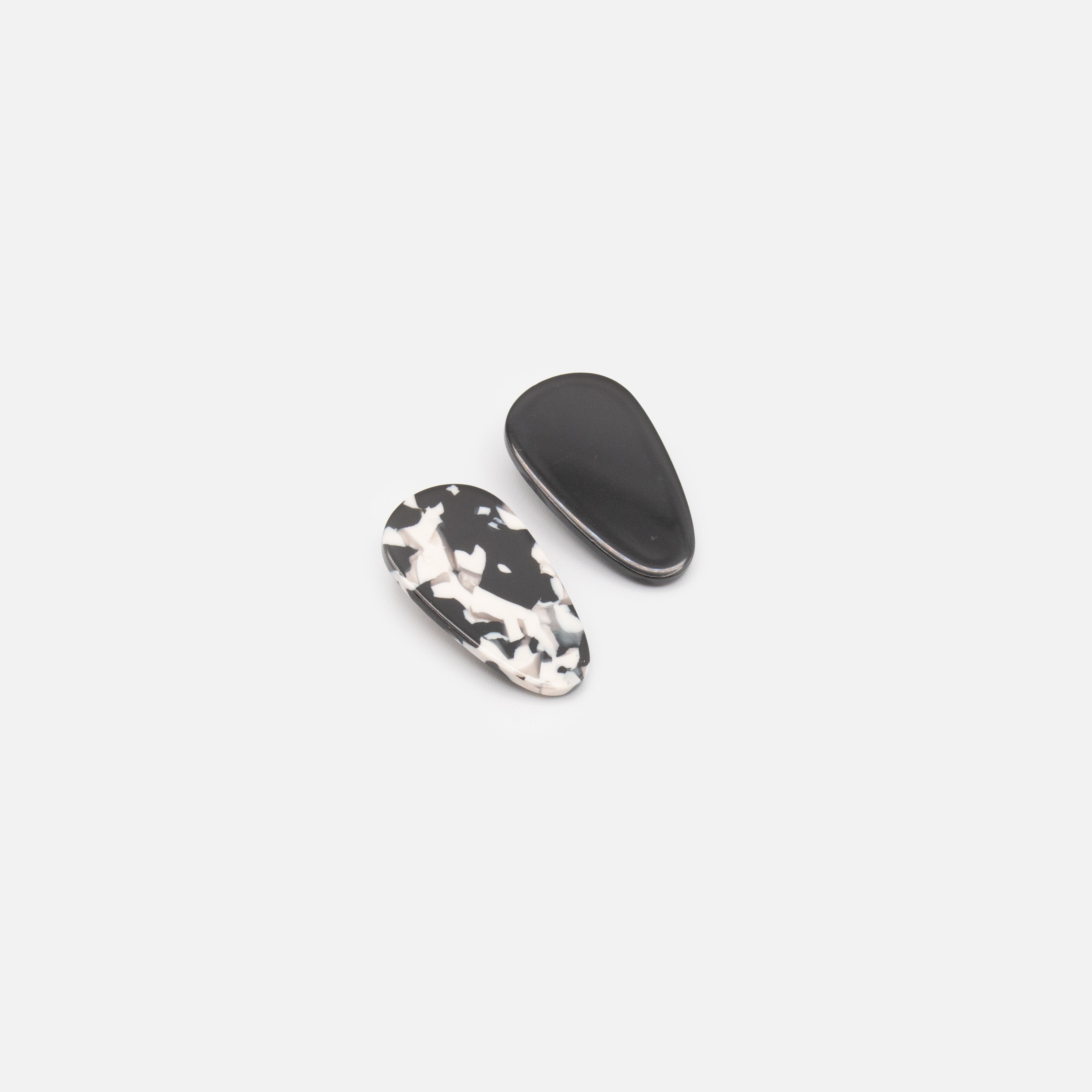 Duo of small black and speckled clips