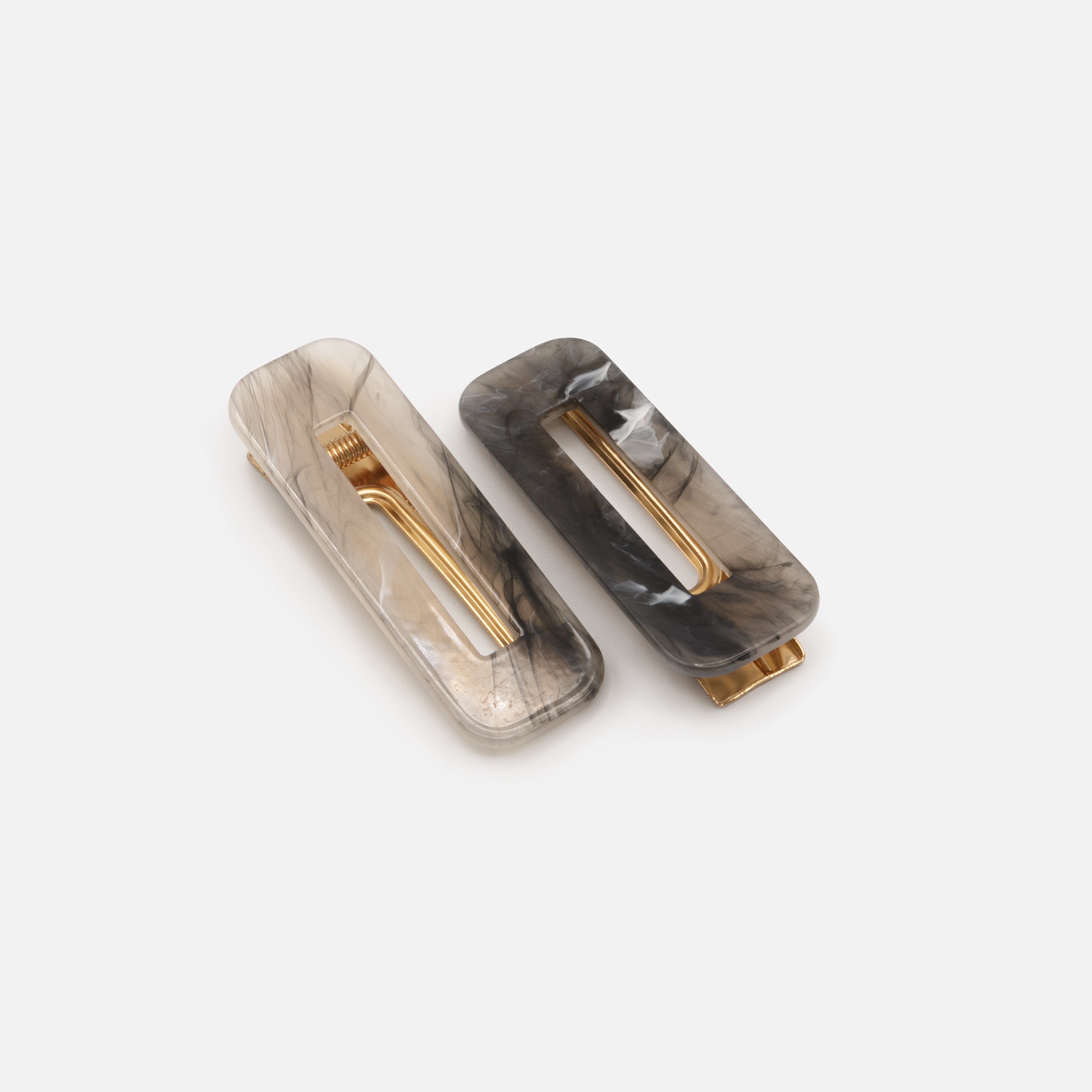 Duo of neutral toned plastic clips