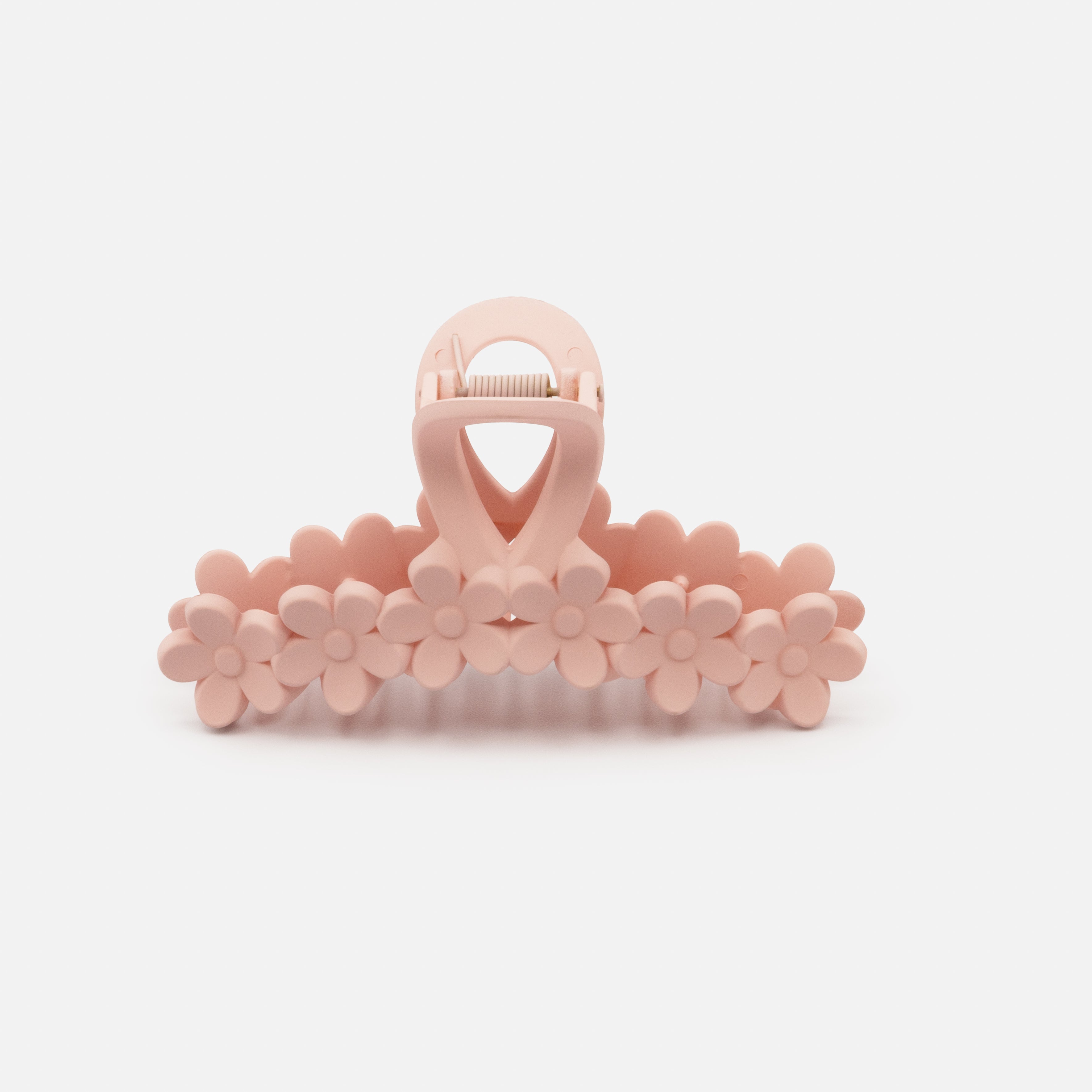 Old pink plastic flower clip with a matte finish