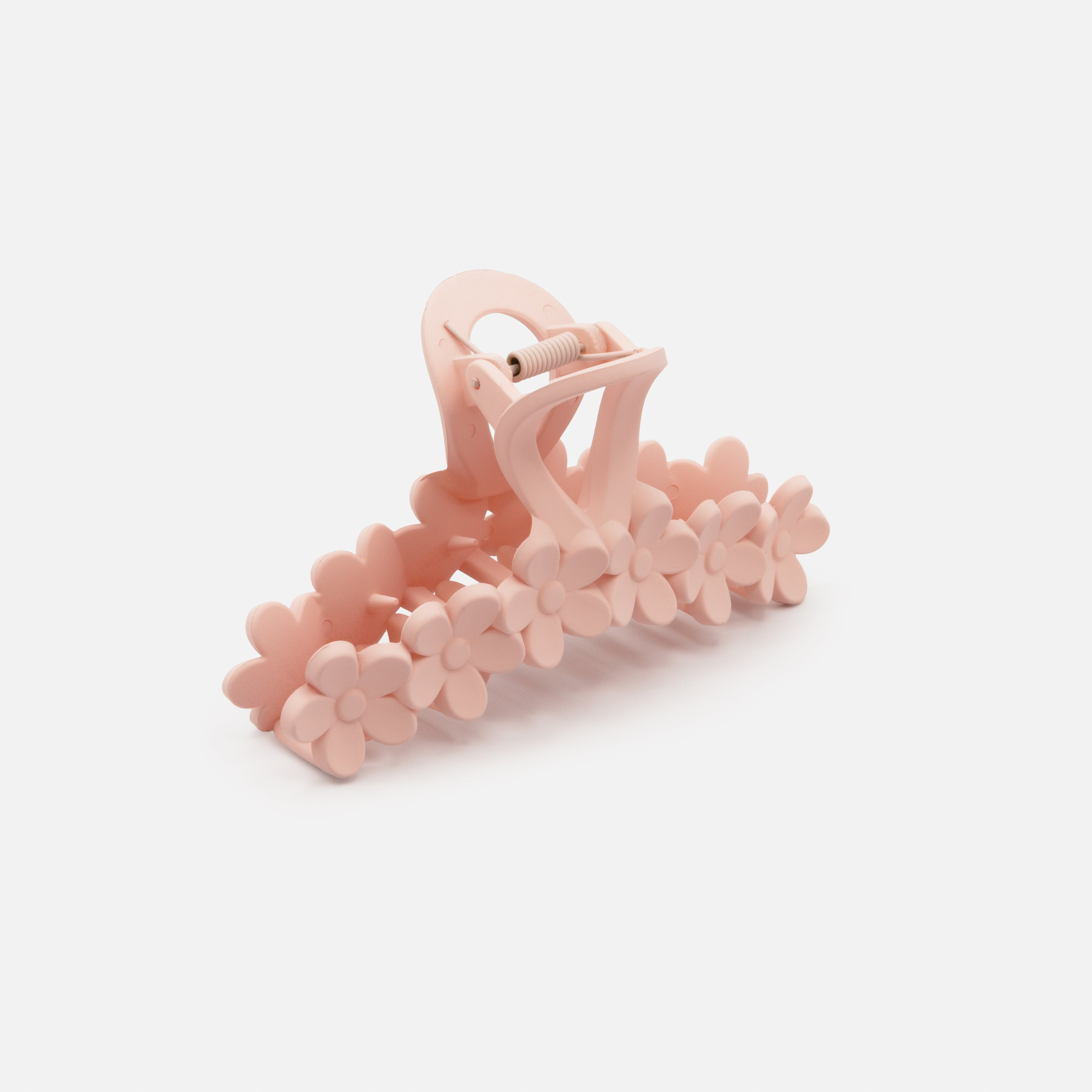 Old pink plastic flower clip with a matte finish