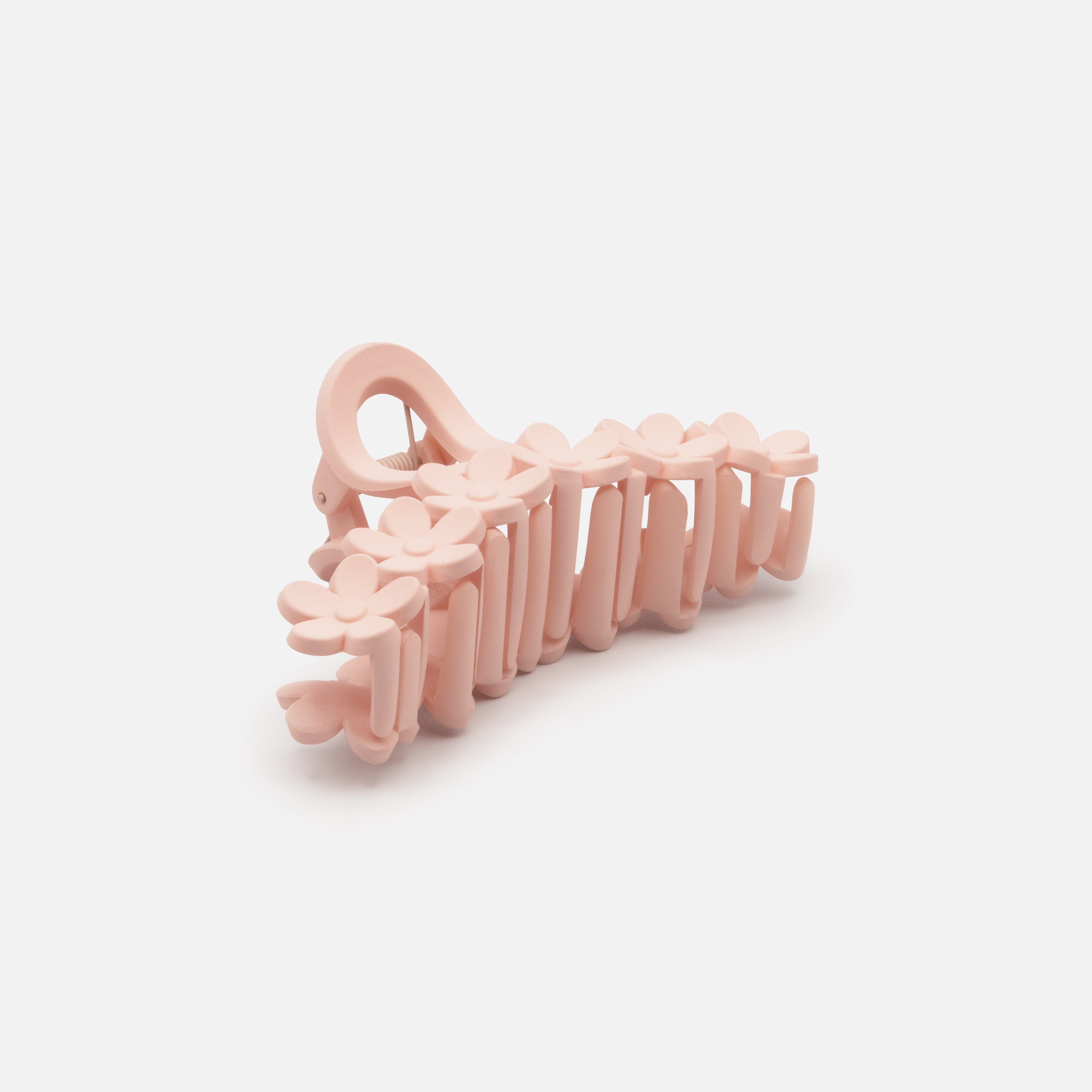 Old pink plastic flower clip with a matte finish