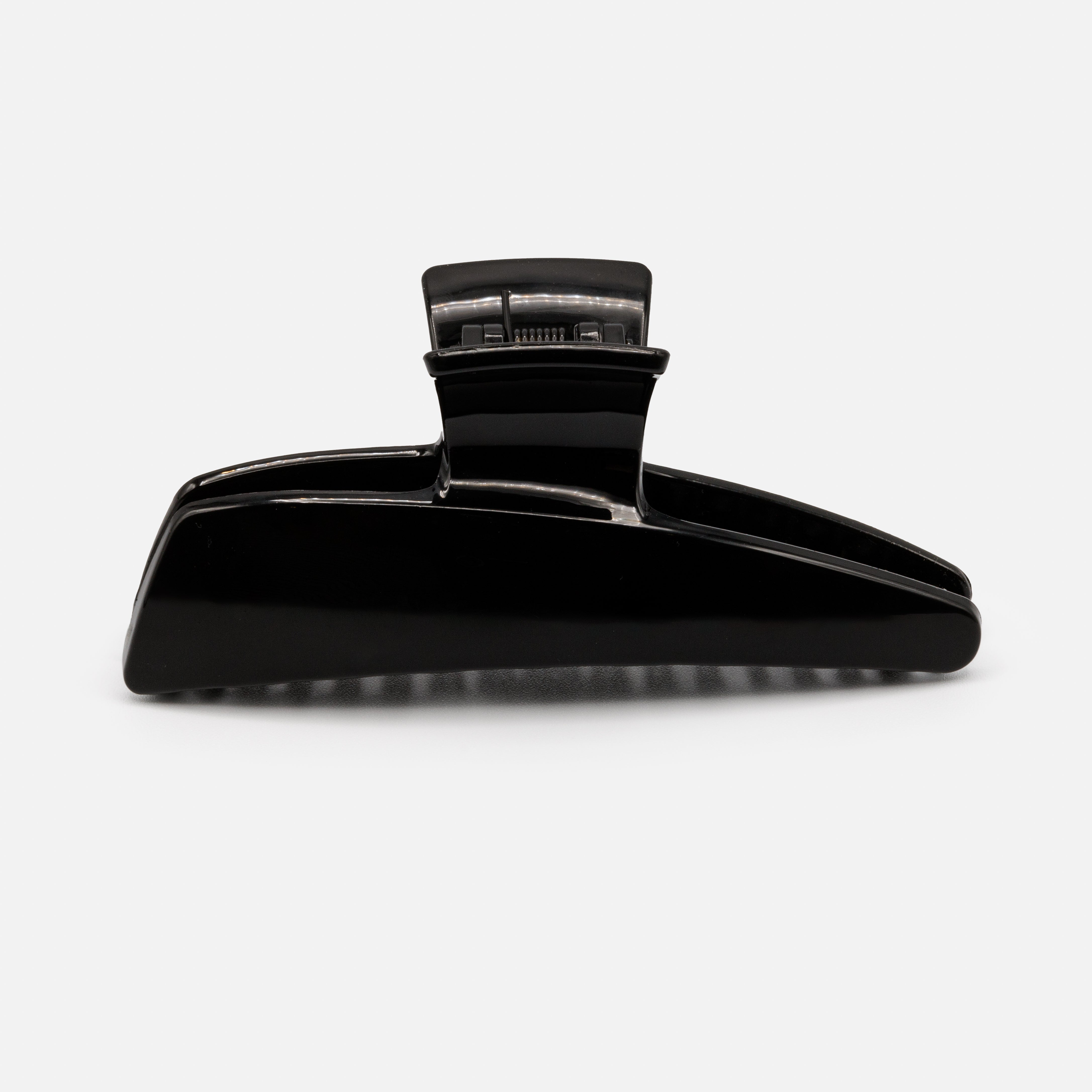 Black geometric plastic clip with a glossy finish