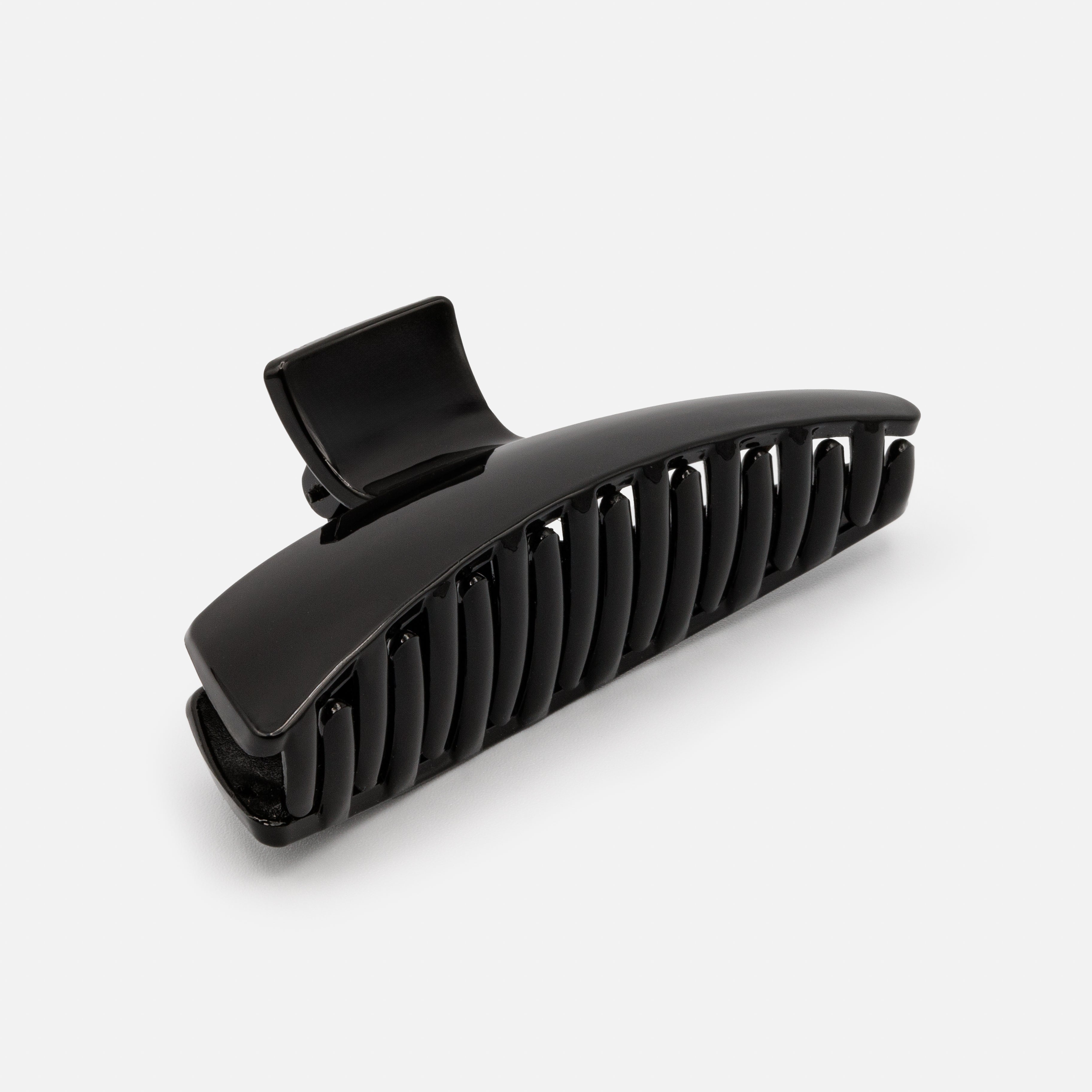 Black geometric plastic clip with a glossy finish