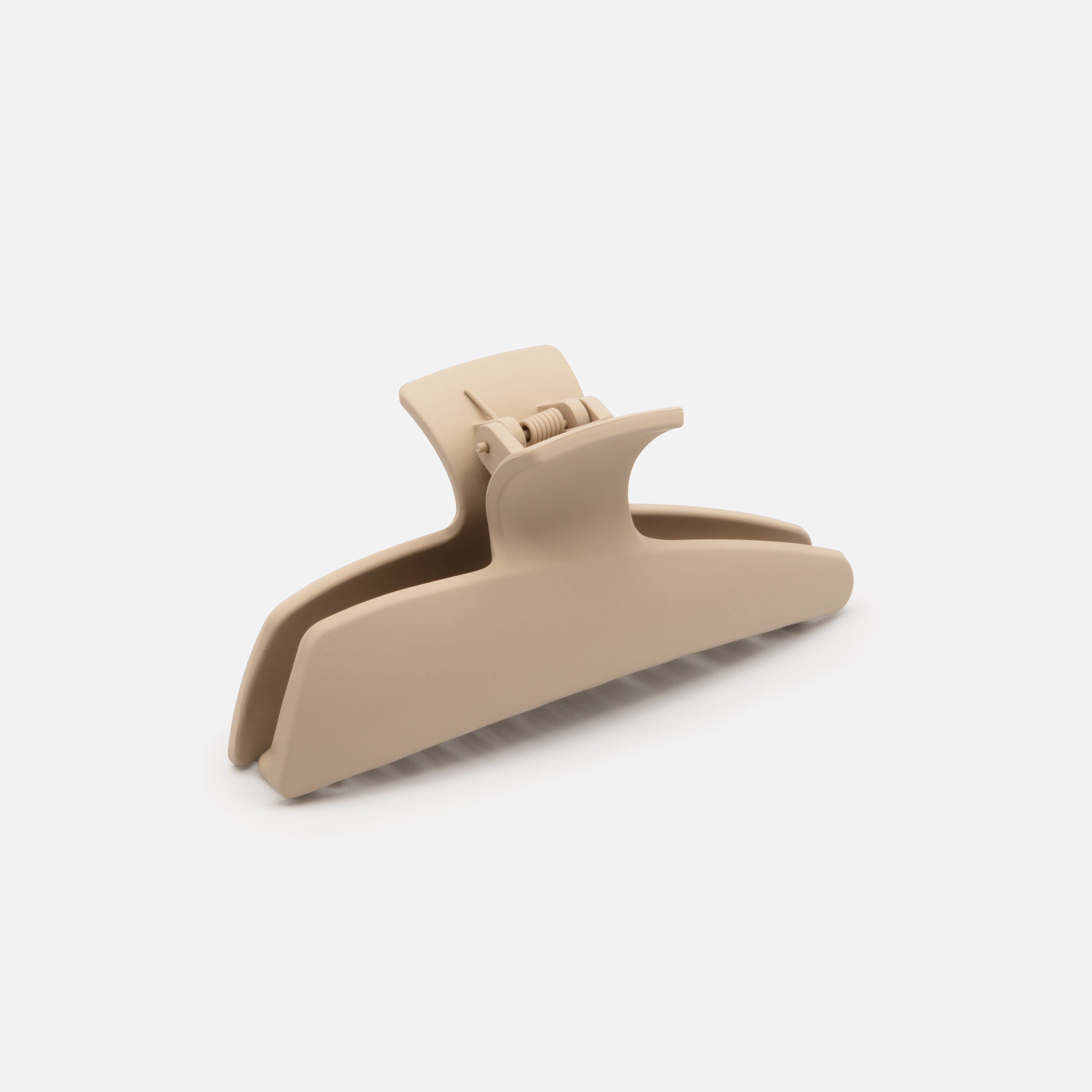 Beige geometric plastic clip with a matte finish