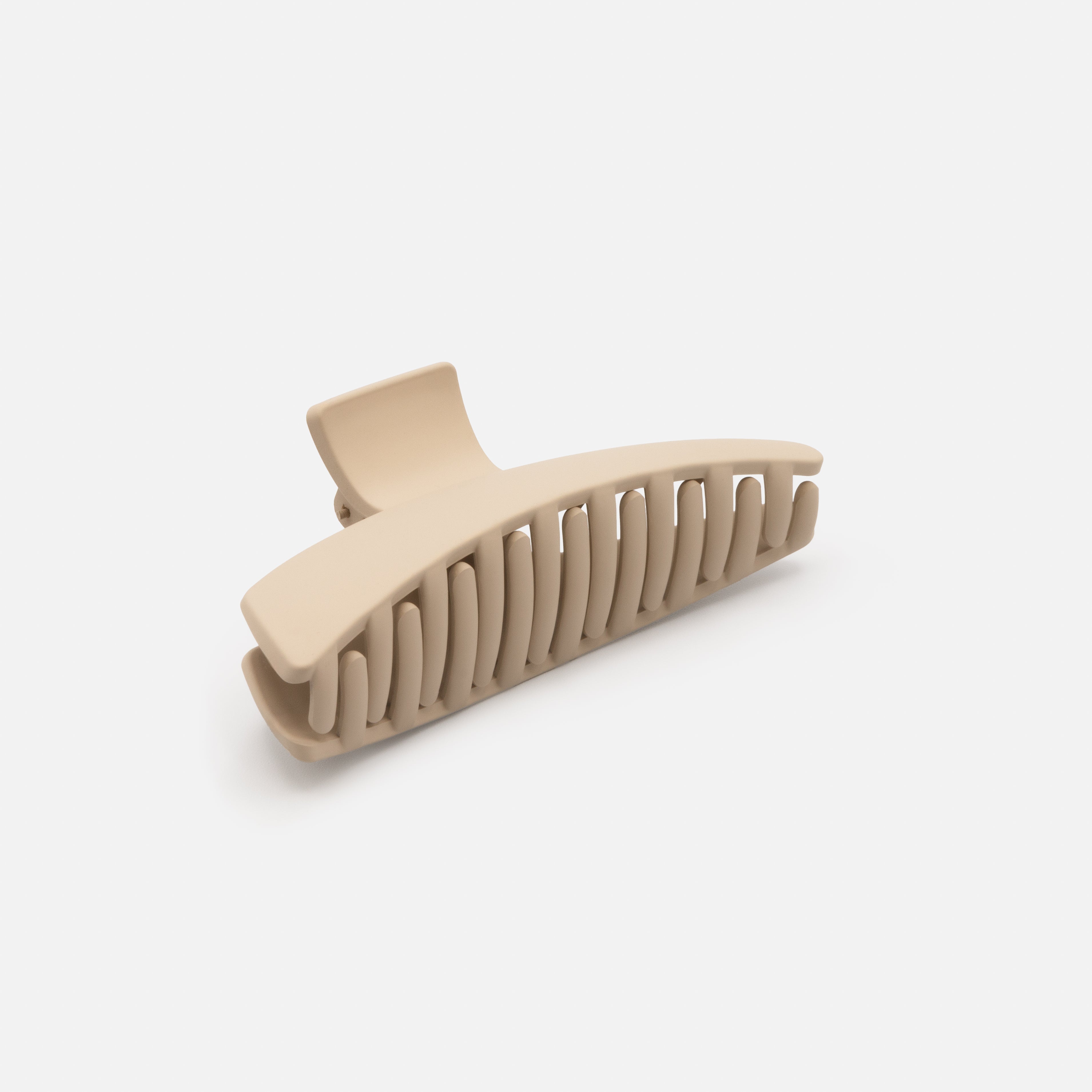 Beige geometric plastic clip with a matte finish