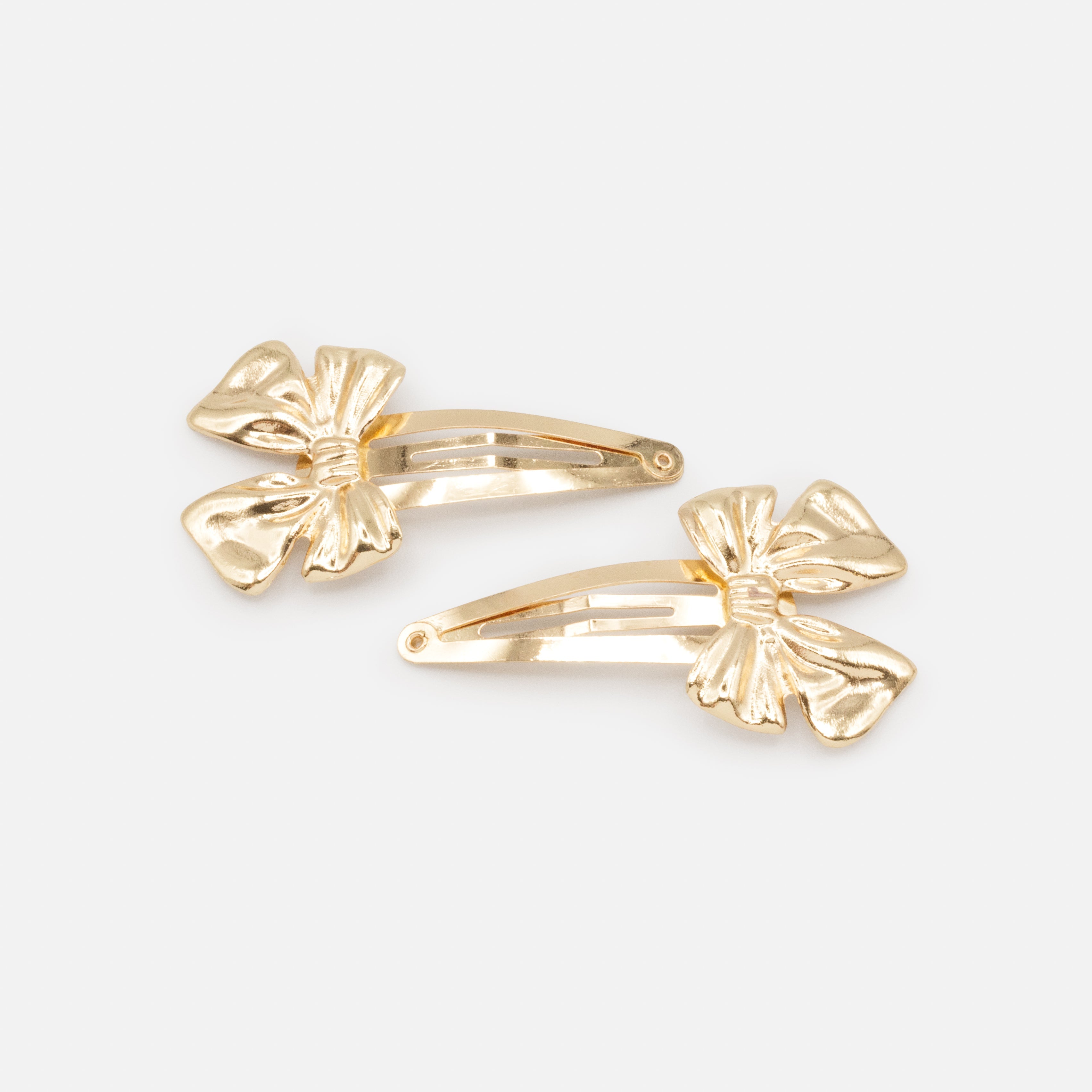 Pair of gold metal clips with buckle