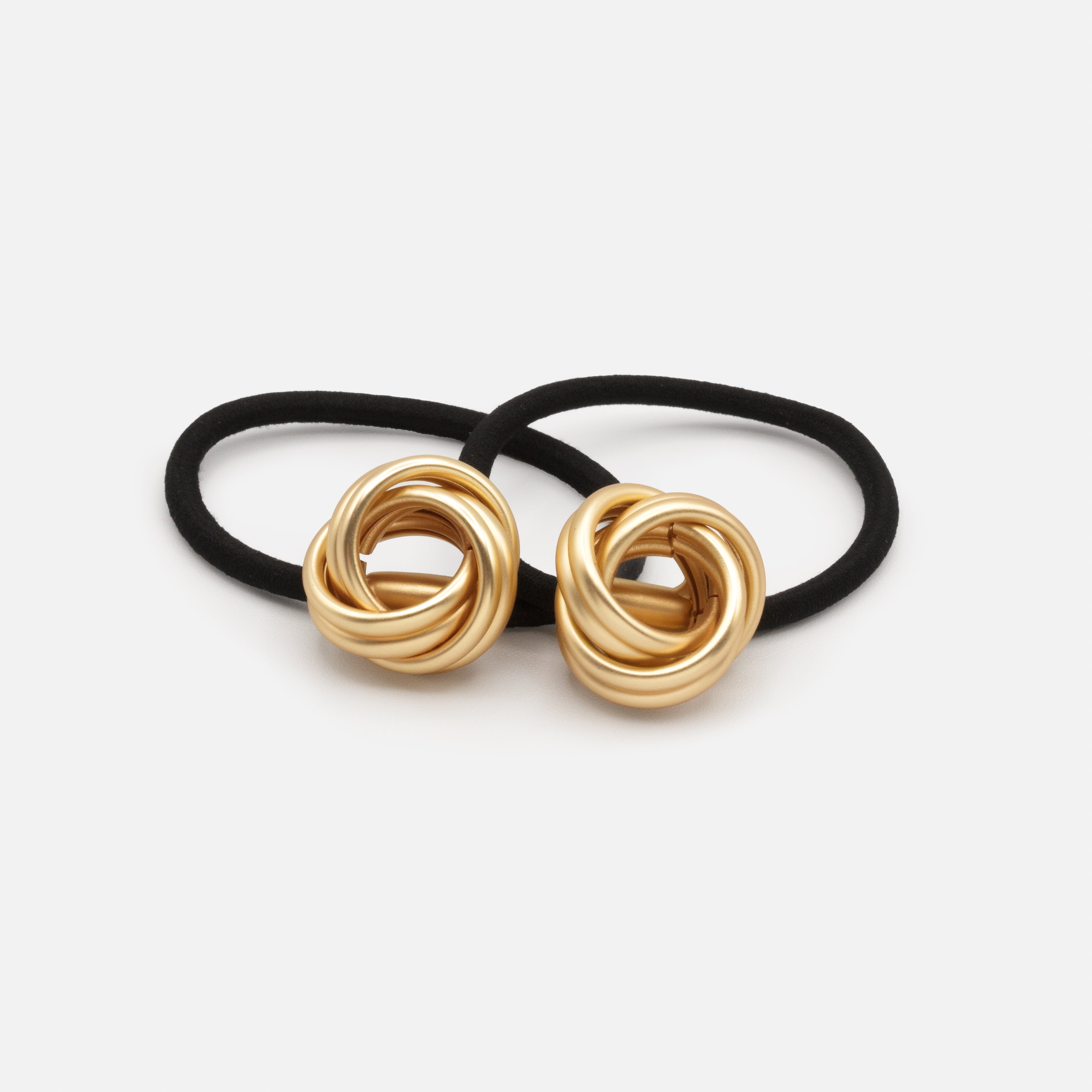 Pair of black elastics with matte gold metal decoration