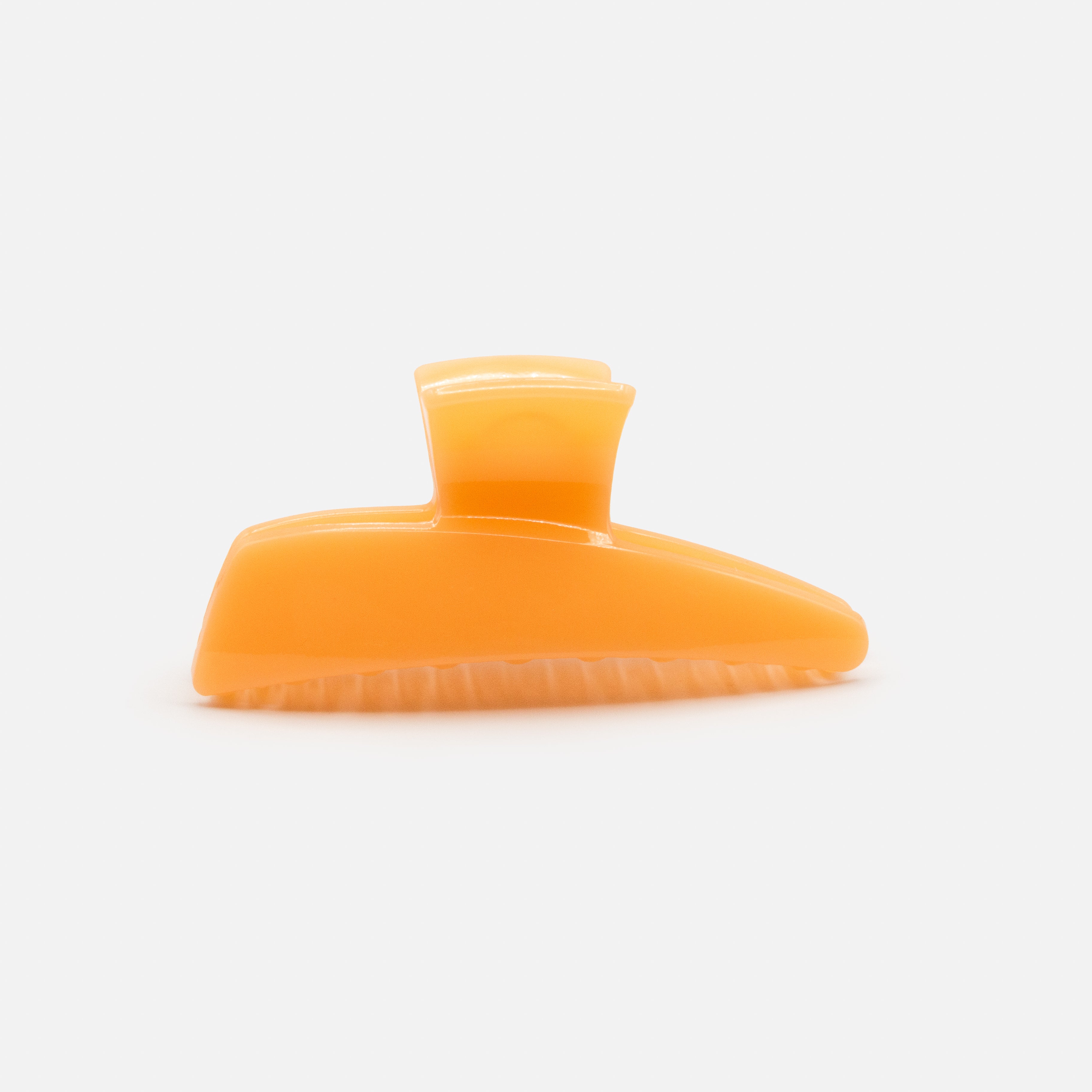 Geometric peach plastic clip with glossy finish