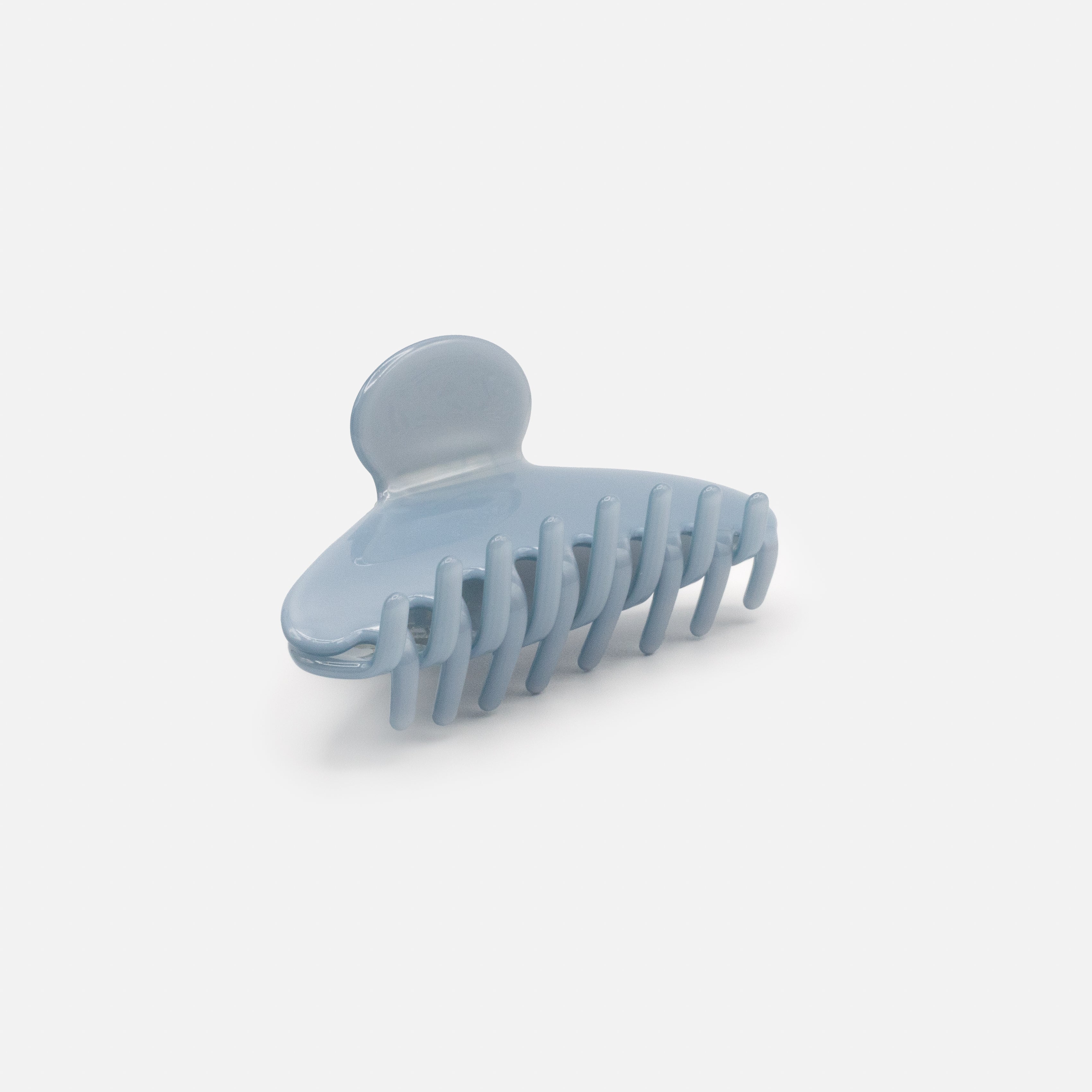 Pale blue plastic clip with a glossy finish