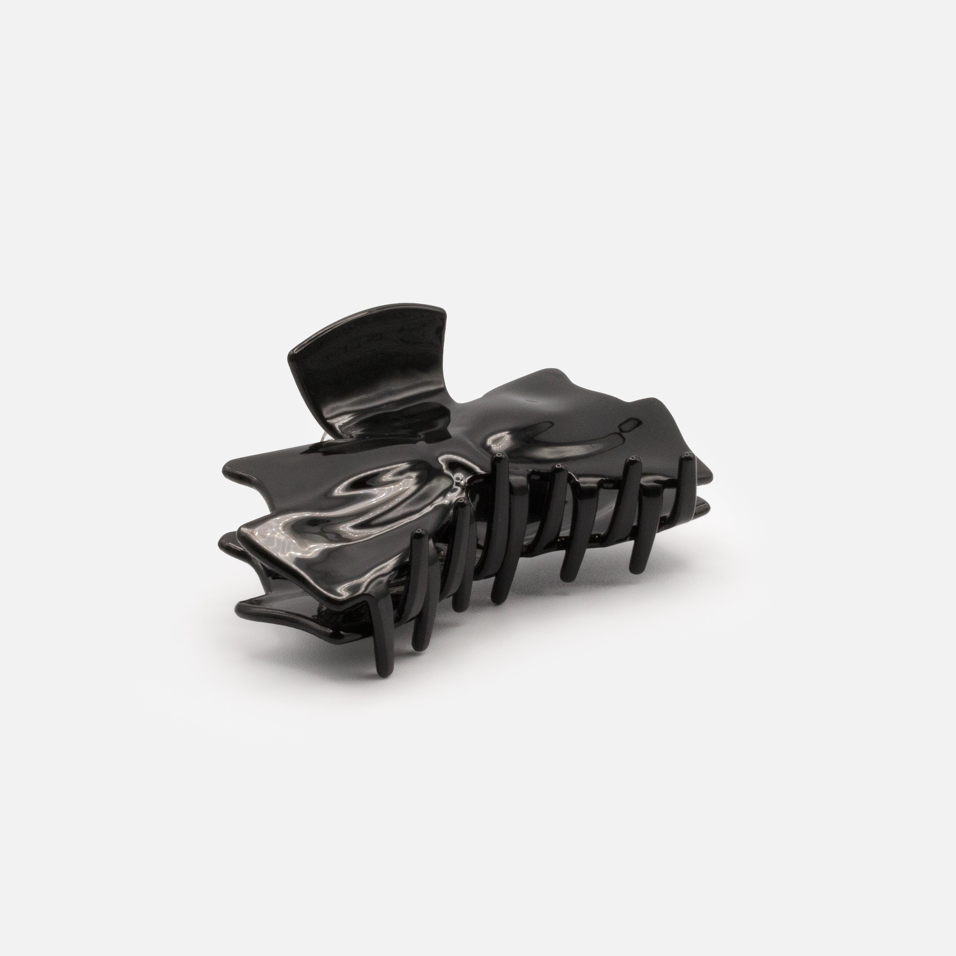 Black plastic loop clip with a glossy finish