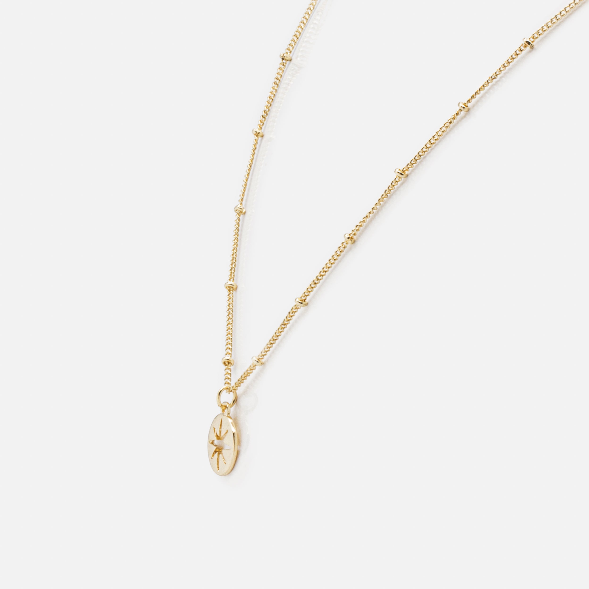 Gold empty star charm necklace