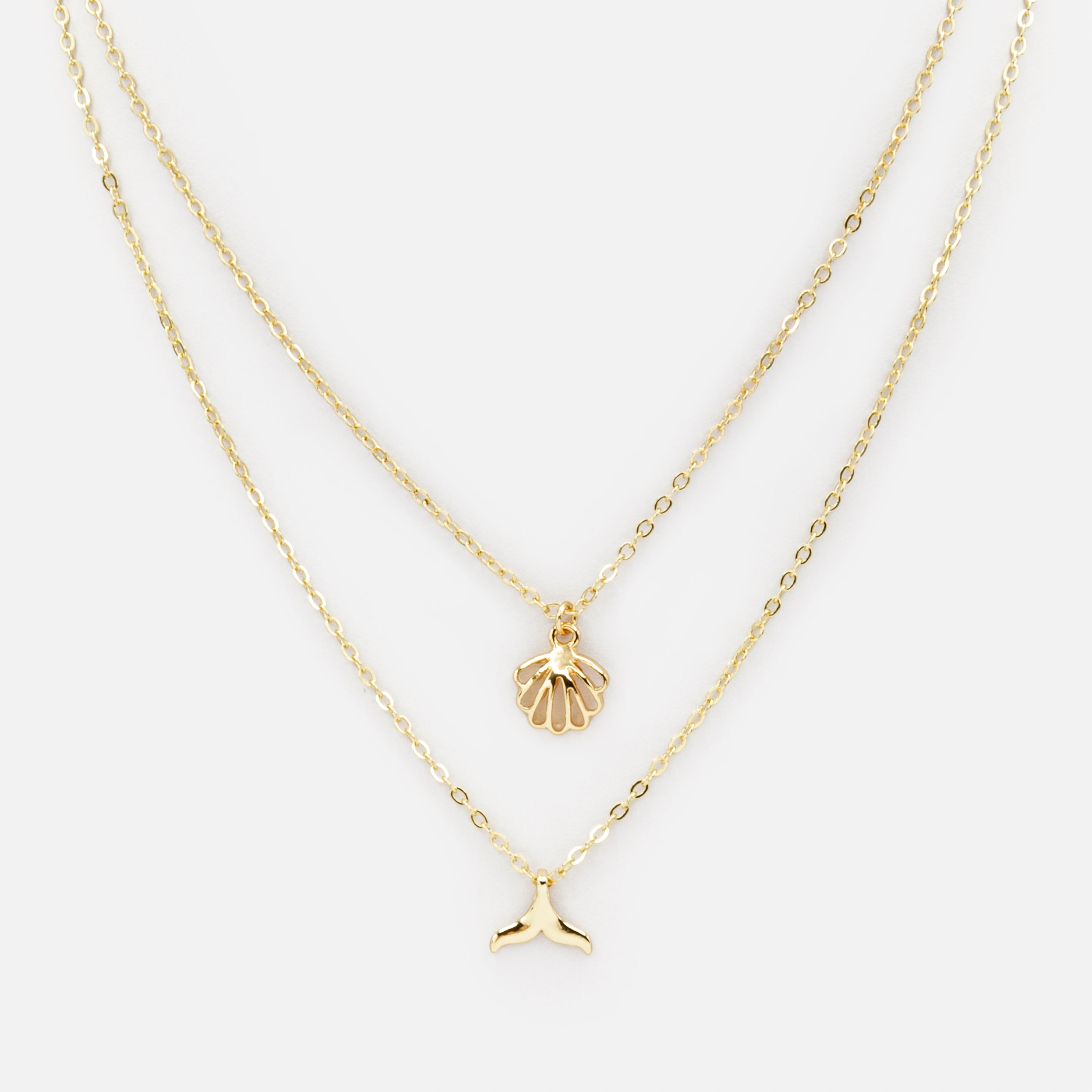 Collier doré double chaîne avec breloques de la mer