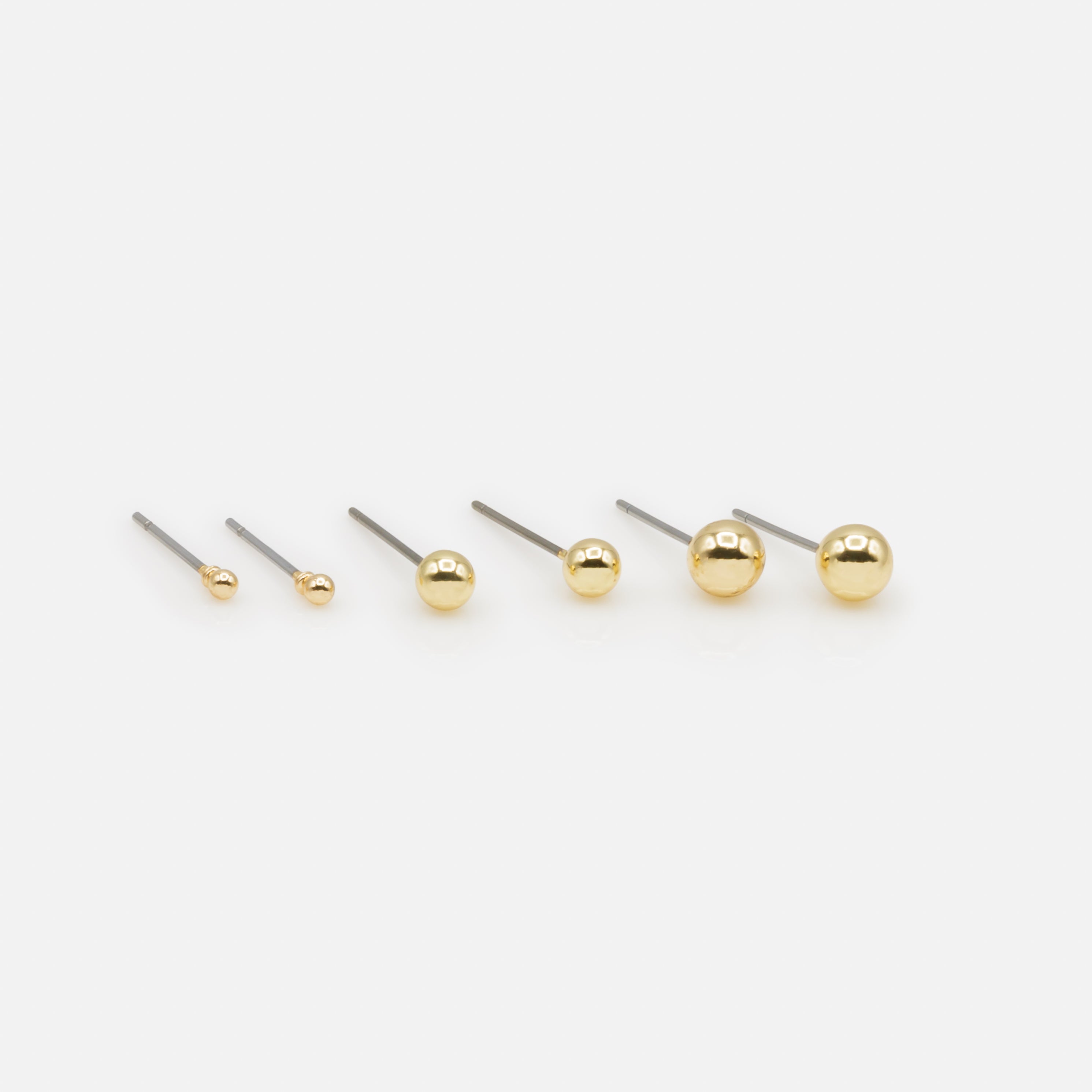 Trio of golden ball earrings in three sizes