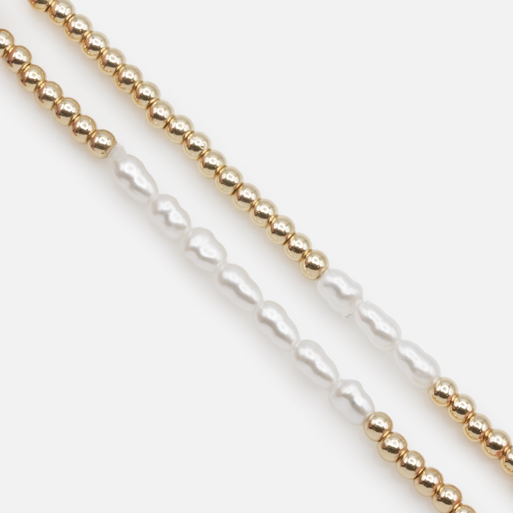 Trio of golden elastic bracelets with synthetic pearls, three ways to wear