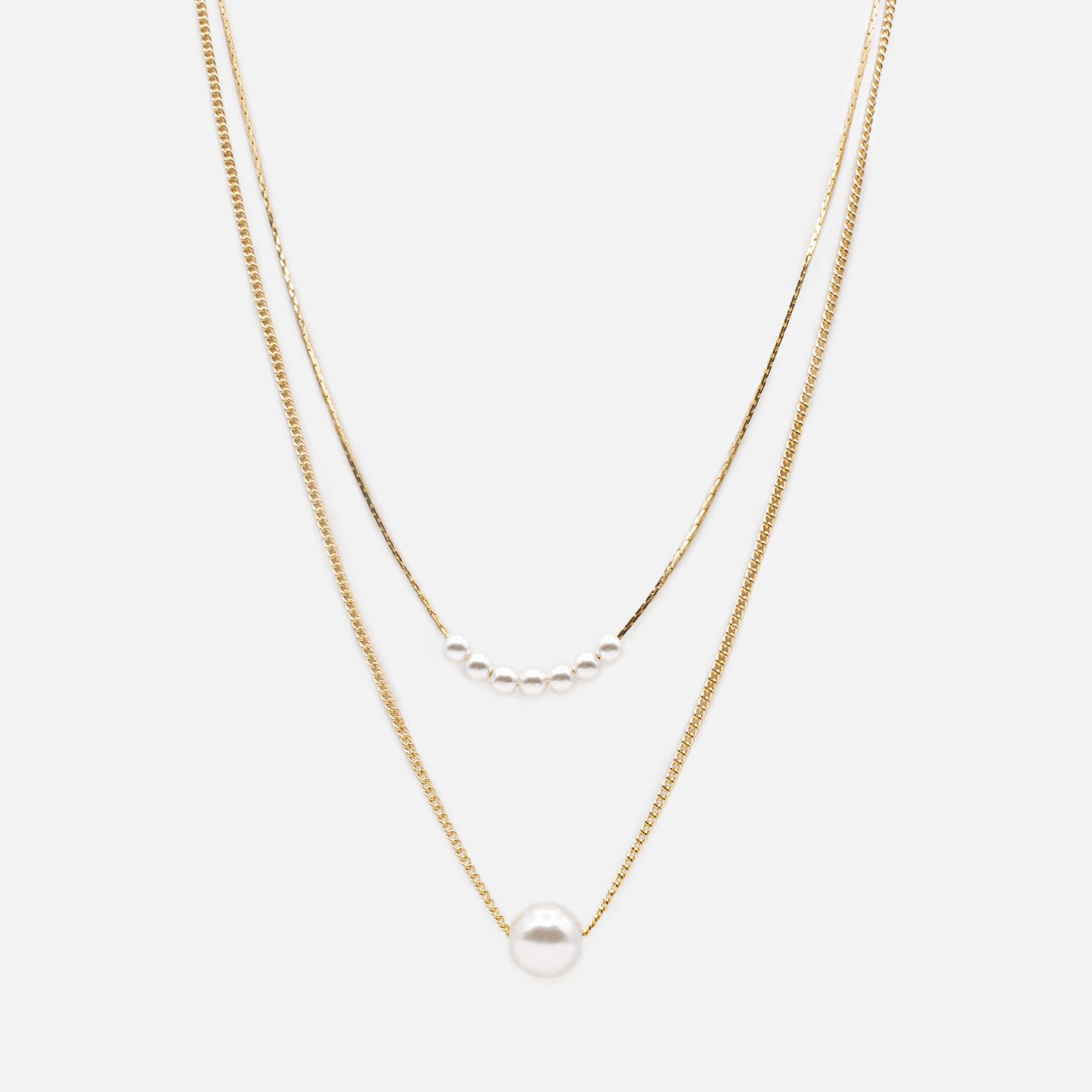 Gold double chain necklace with synthetic round pearls in two sizes