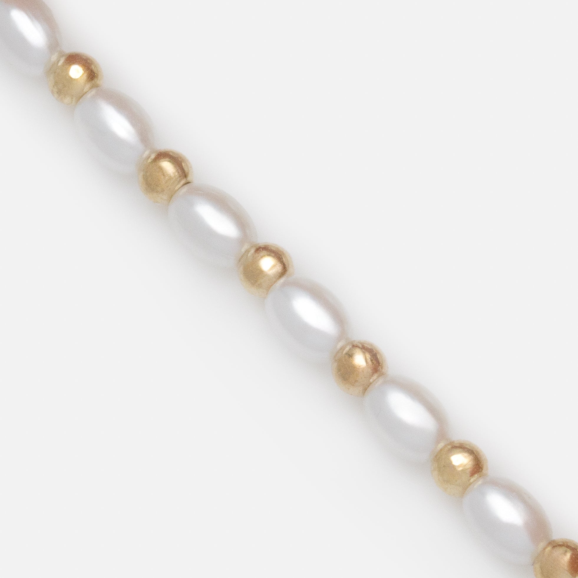 Trio of gold trombone mesh bracelets and pearls