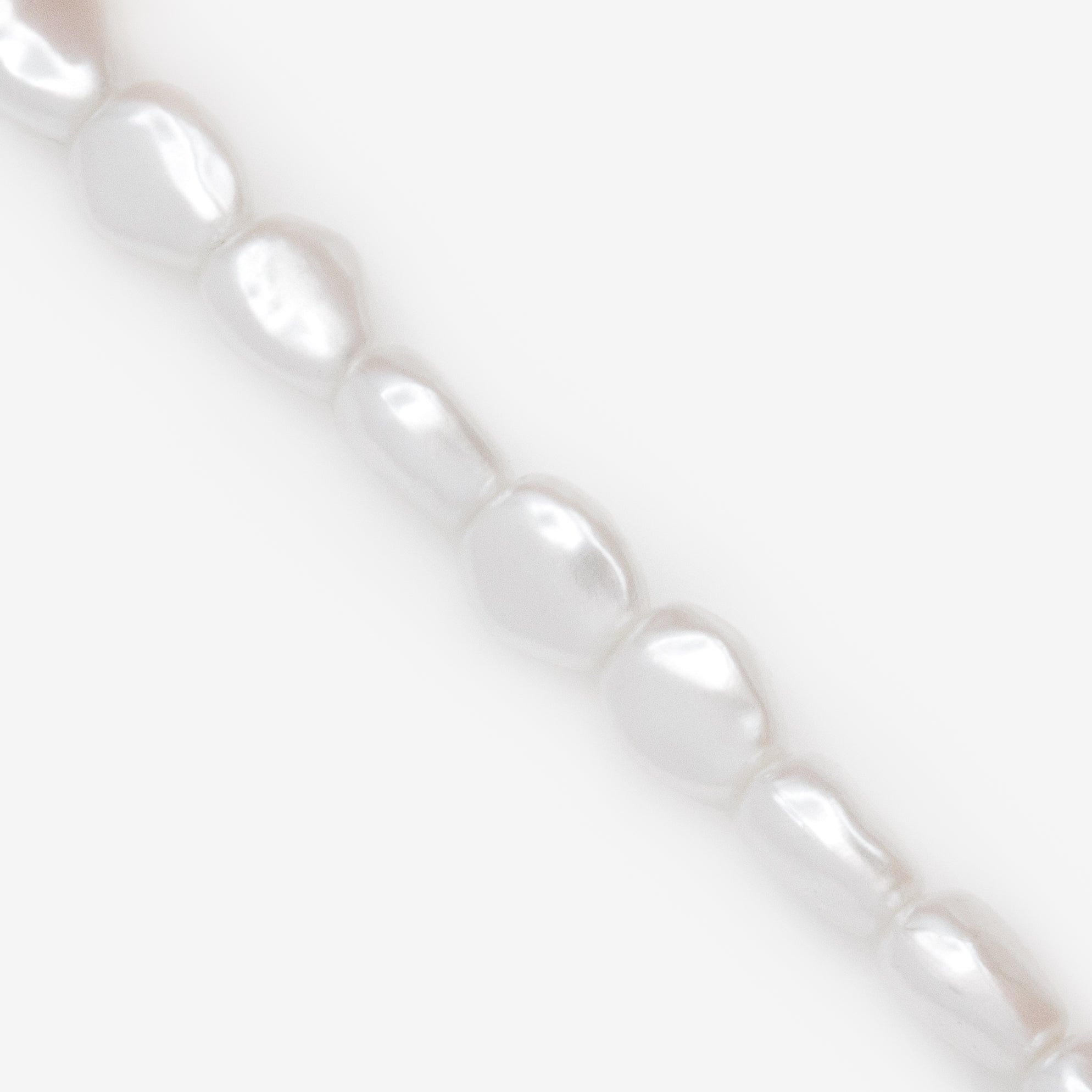 Trio of gold trombone mesh bracelets and pearls