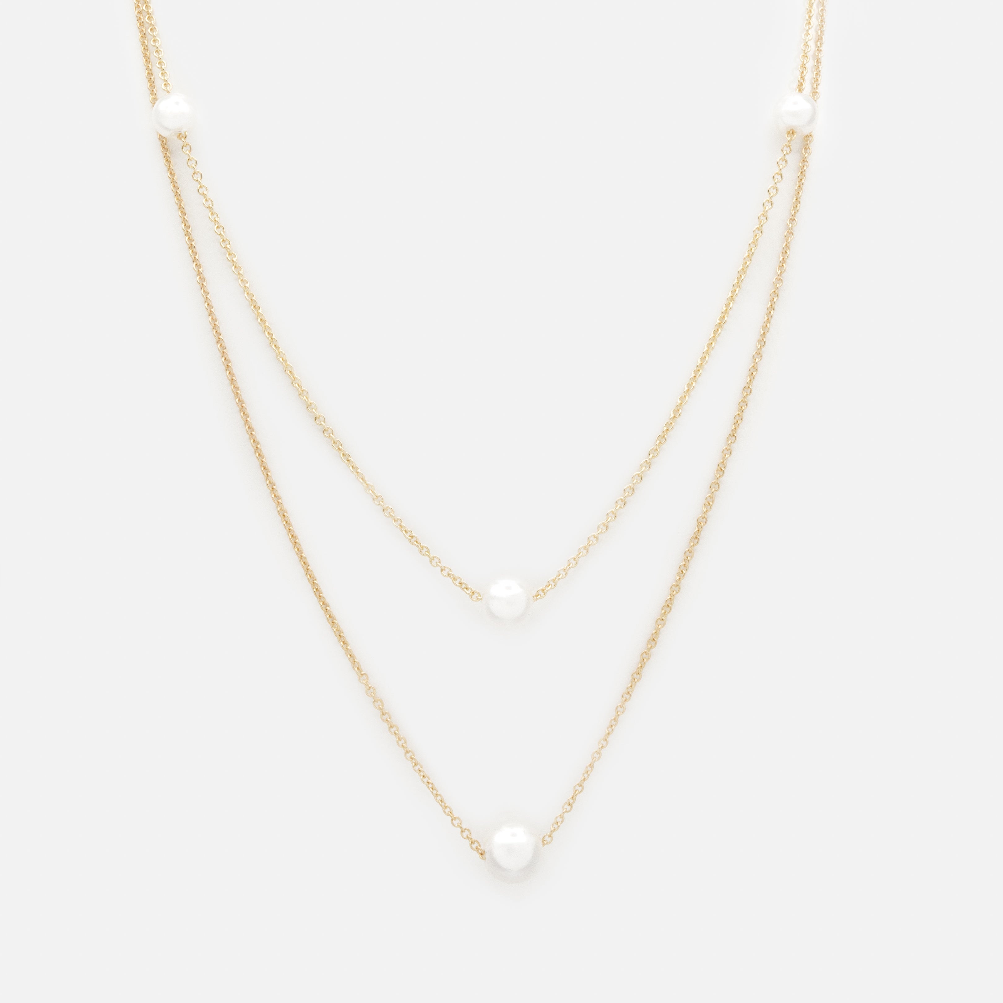 Collier doré double chaîne avec perles rondes