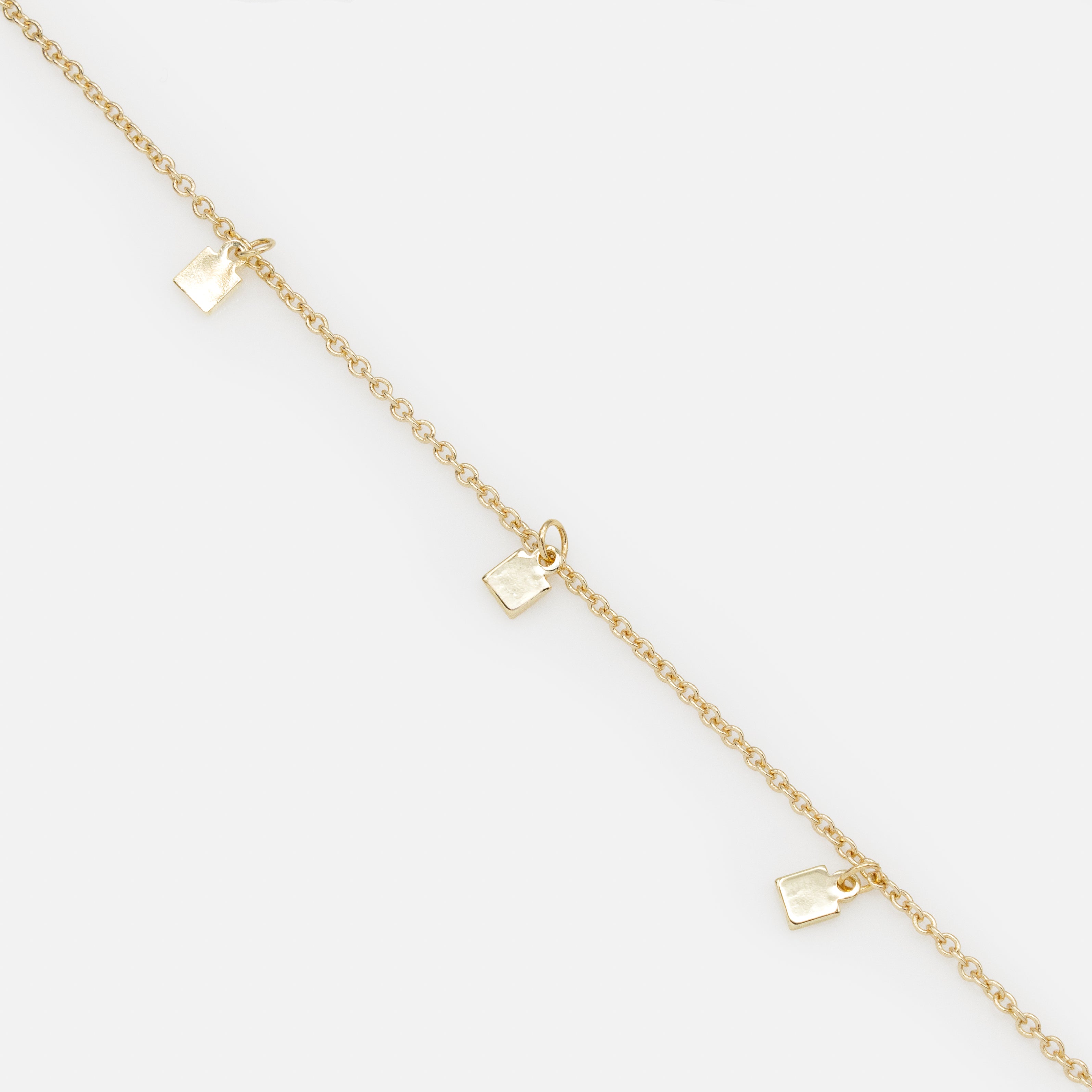 Gold bracelet with small square charms