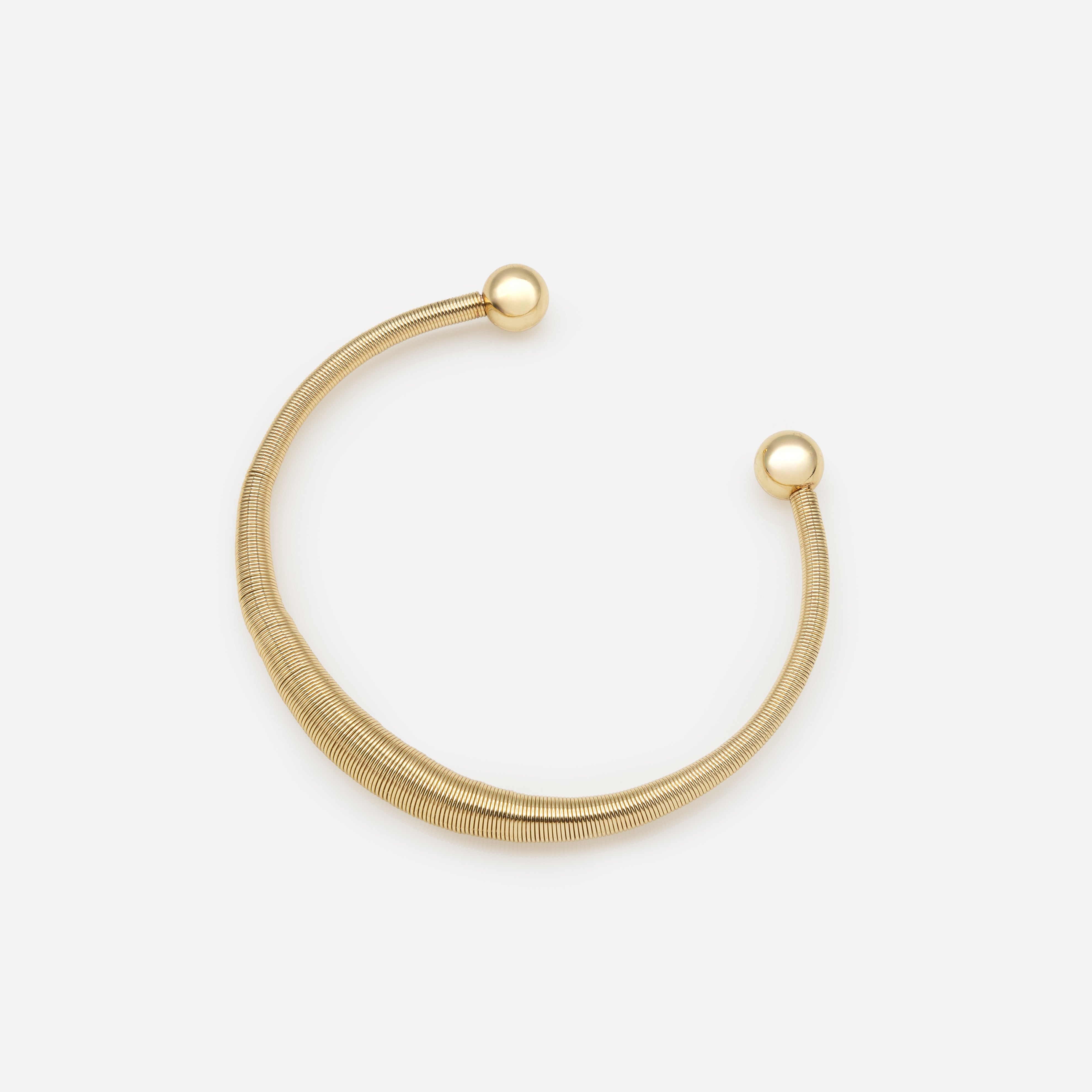 Rigid gold spring effect bracelet