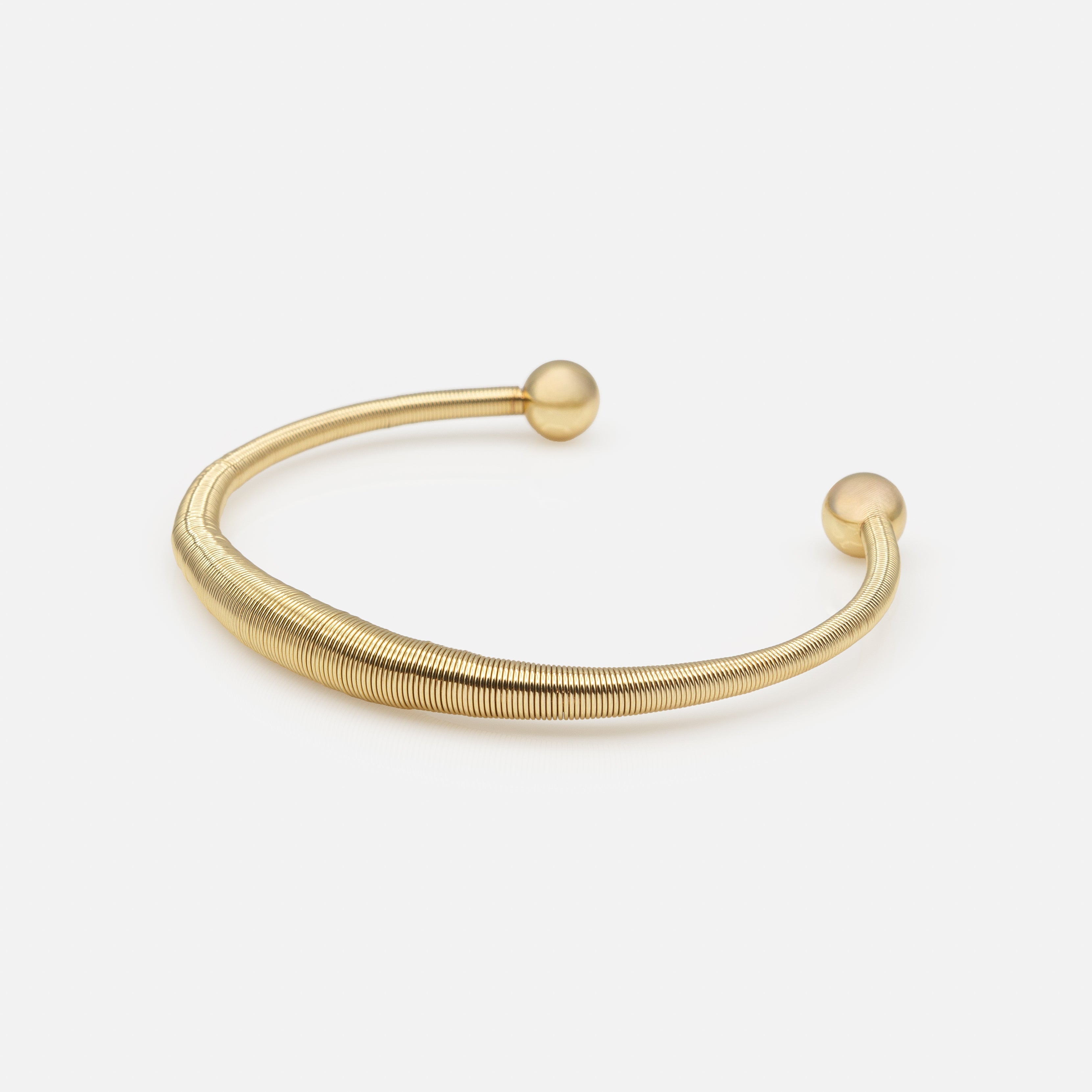 Rigid gold spring effect bracelet