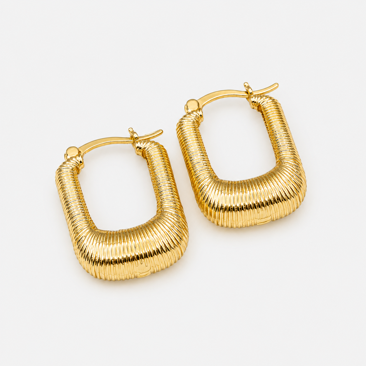 Oval grooved gold earrings