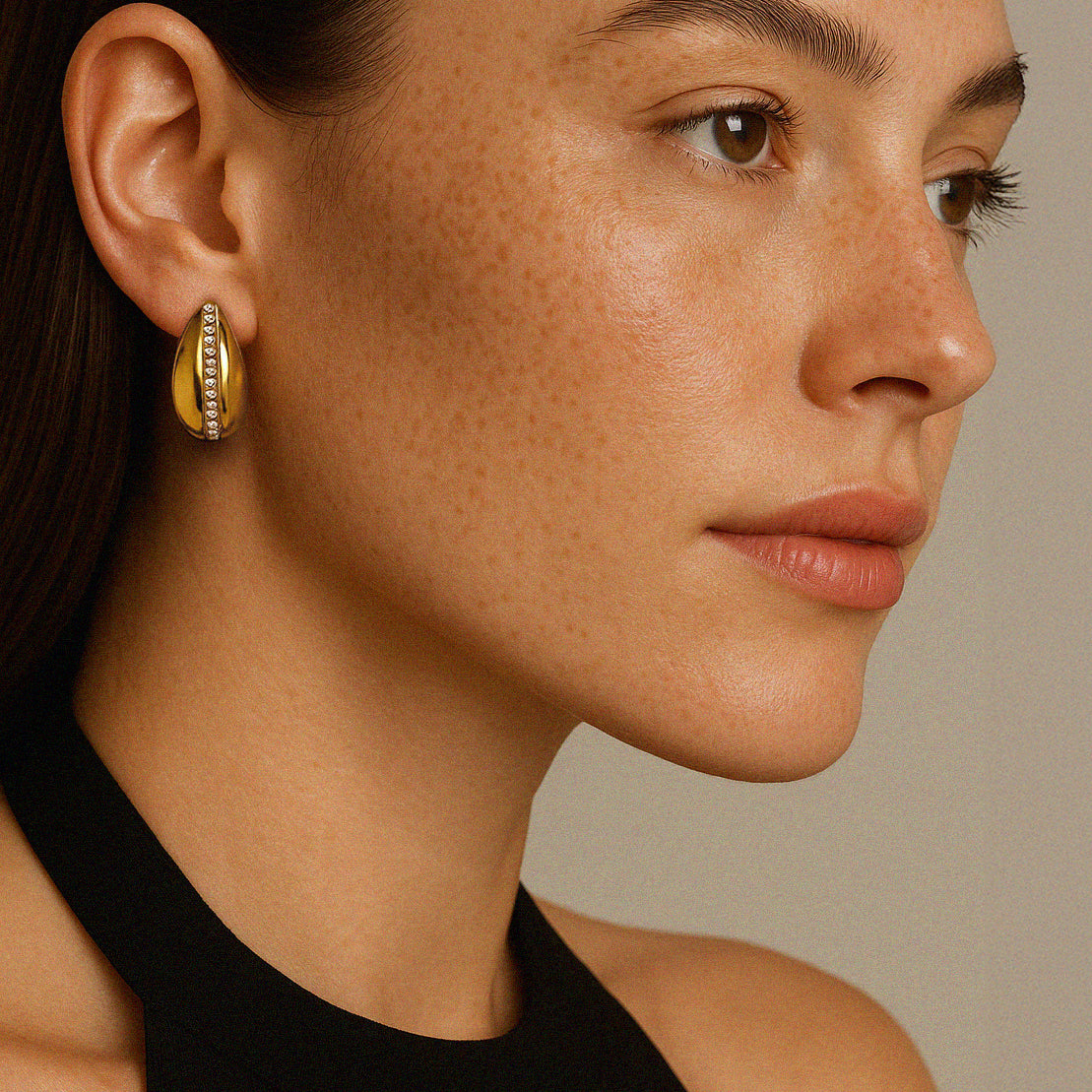 Gold-plated stainless steel earrings with a row of cubic zirconia stones