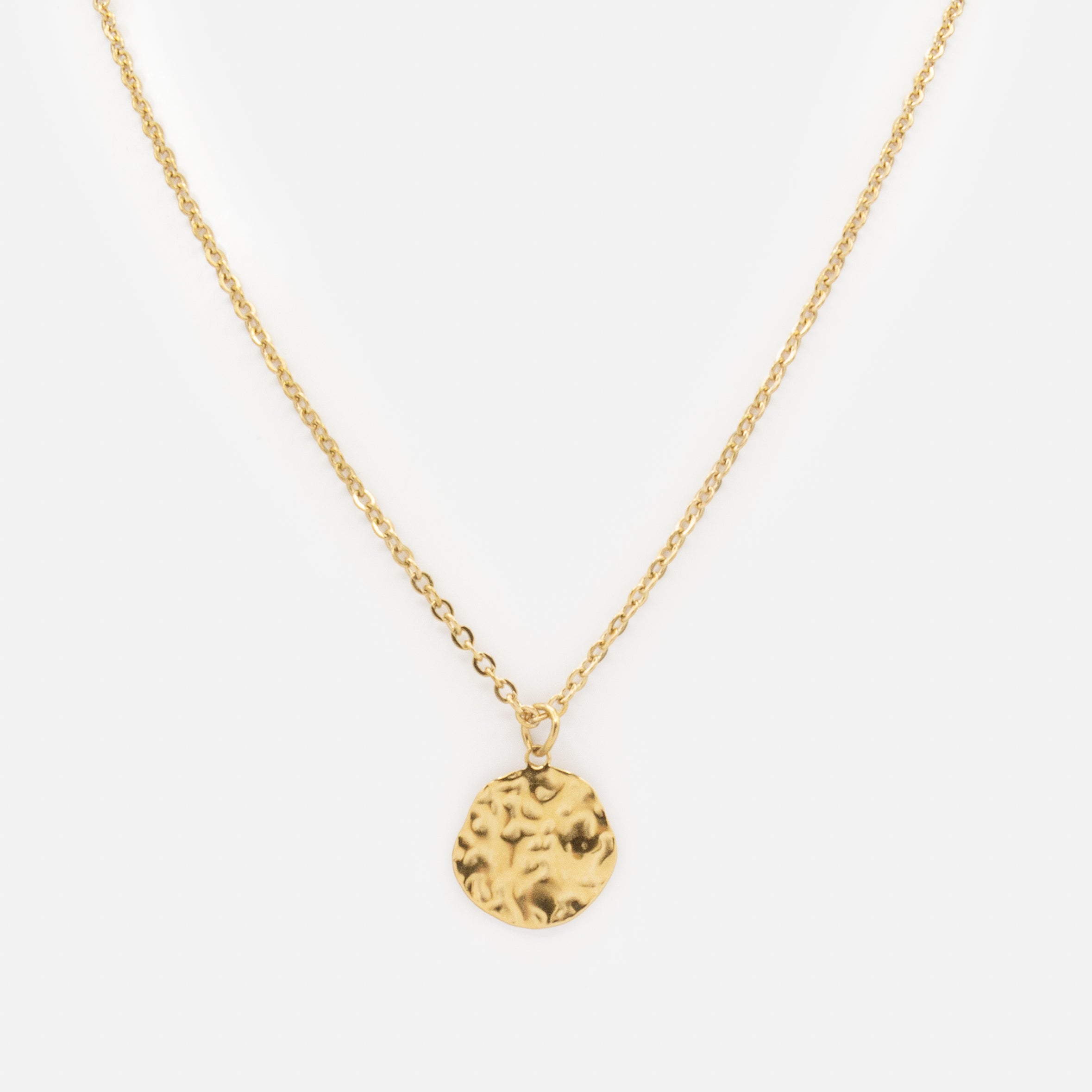 Gold necklace with imperfect hammered circle in stainless steel