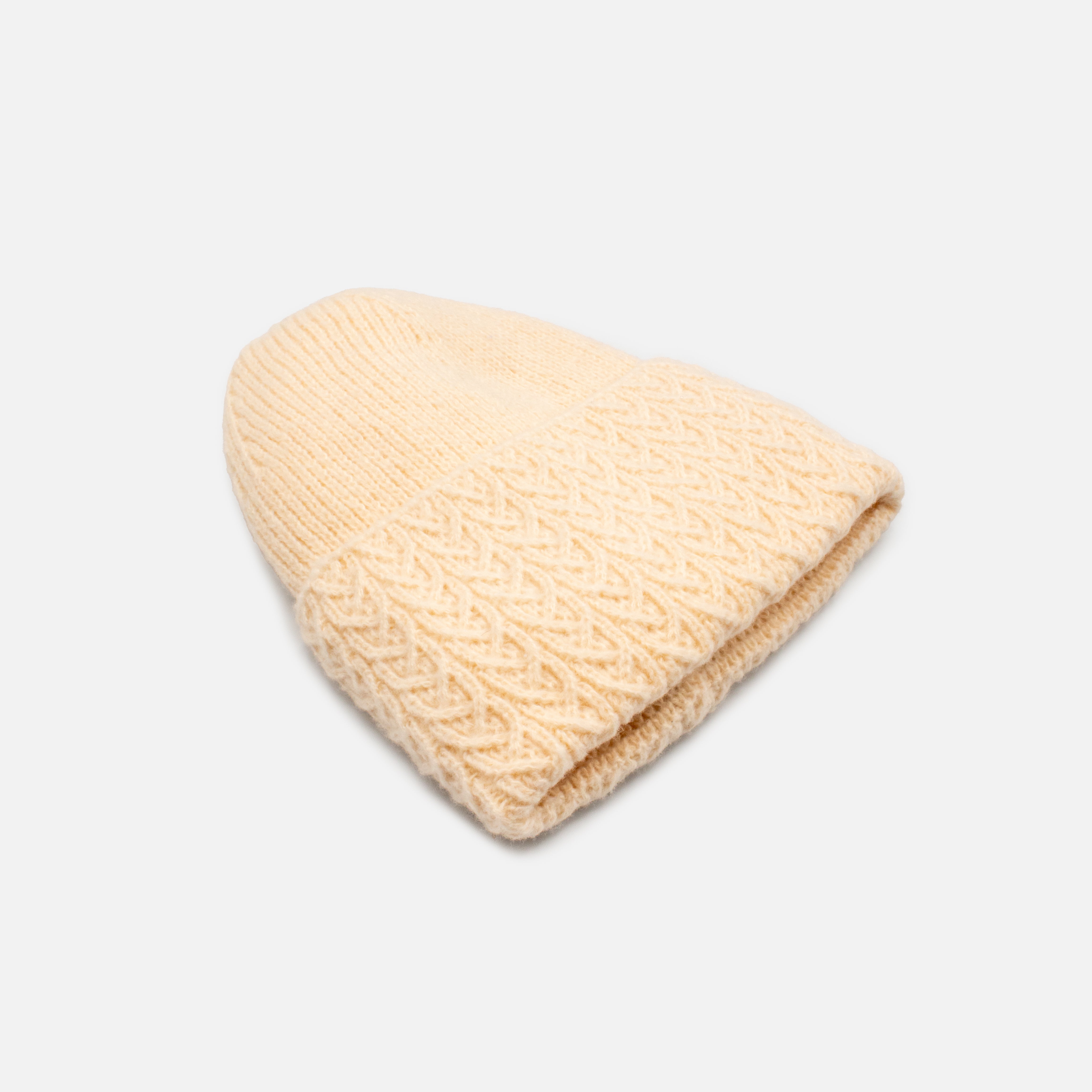 Beige knit beanie with braided flap
