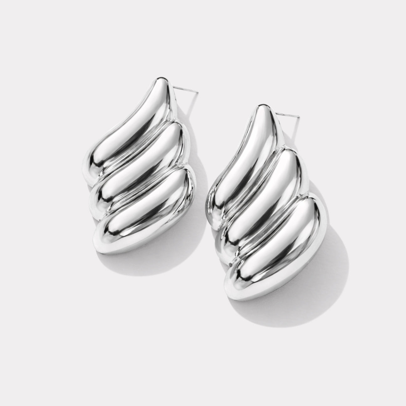 Bizou SF253E003SL – Silver chunky wave stud earrings in stainless steel, sculptural ribbed design, angled view