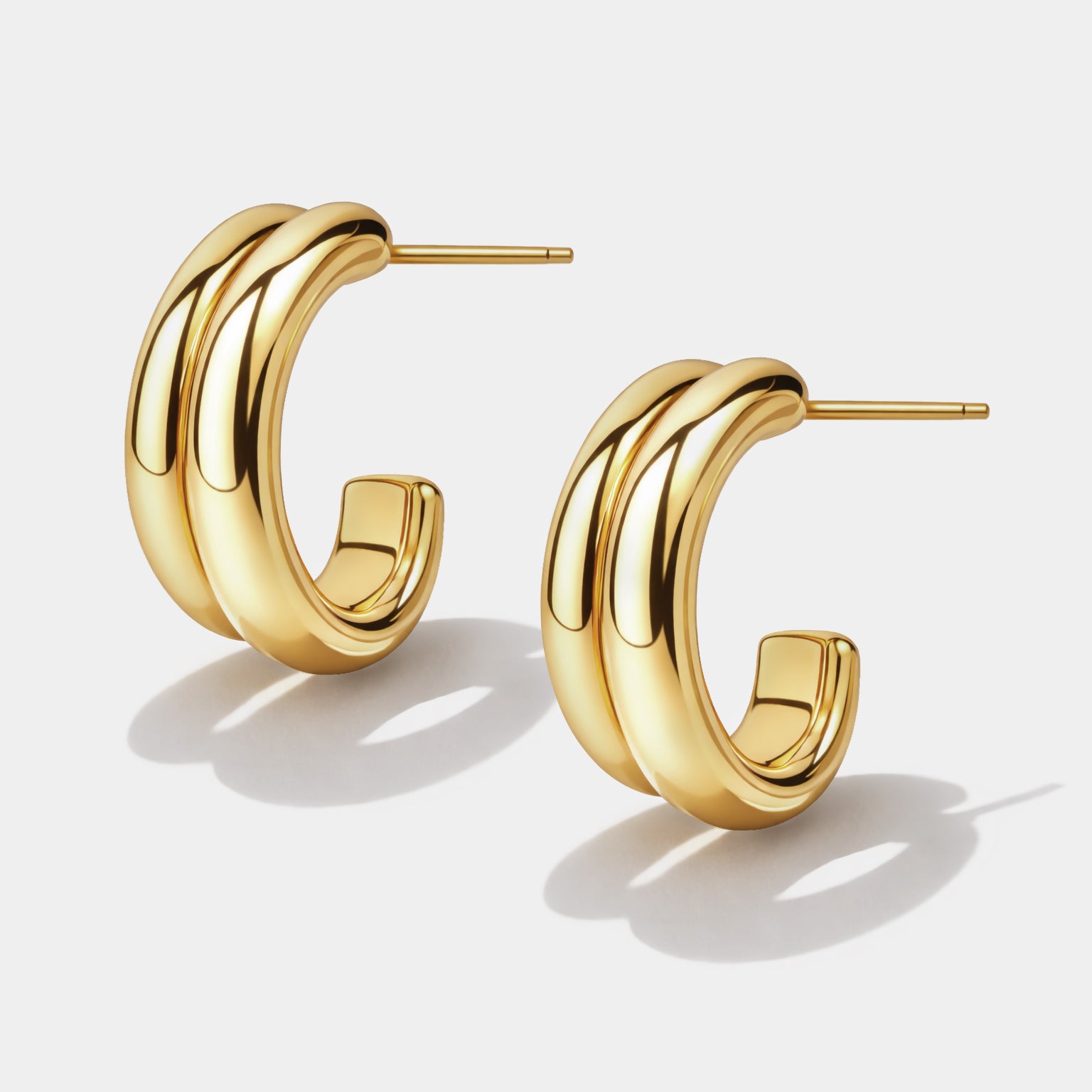 Bizou SF253E012GL – Gold stainless steel chunky double claw hoop earrings, sculptural layered design, side view, Bizou jewelry