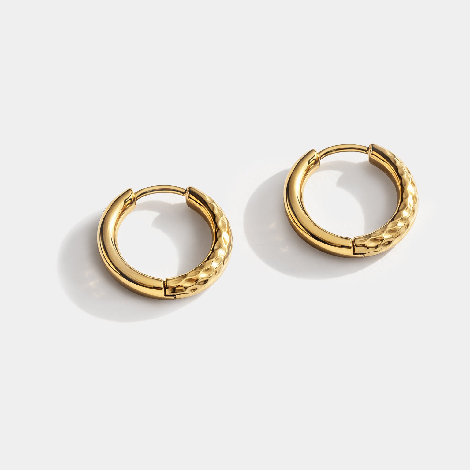 Bizou SS251E018GL – Gold stainless steel huggie hoop earrings with hammered honeycomb texture, high-polish inner band, front view, Bizou jewelry