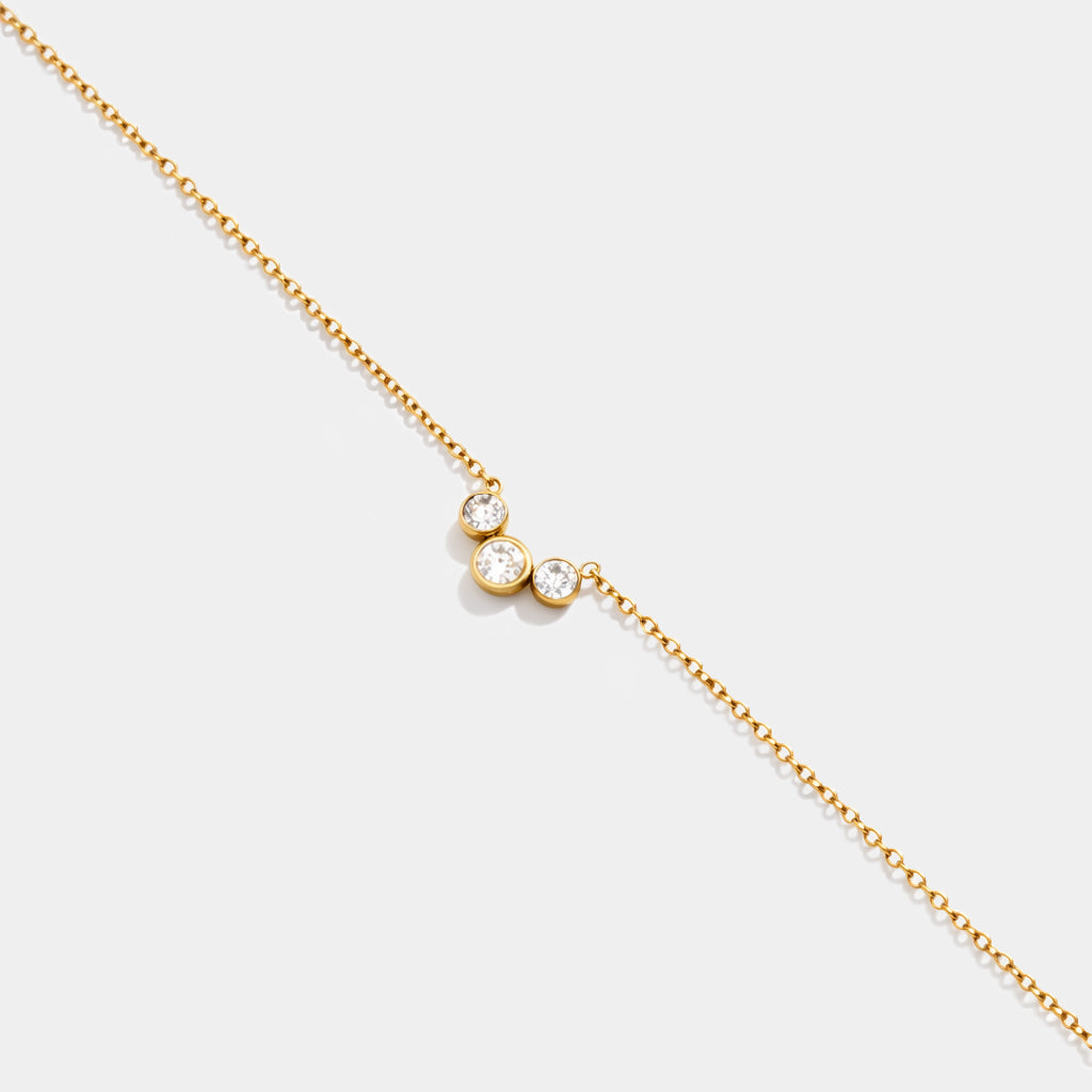 Bizou SS253B019GL – Close-up of gold stainless steel bracelet with three graduating bezel-set cubic zirconia stones, Bizou jewelry
