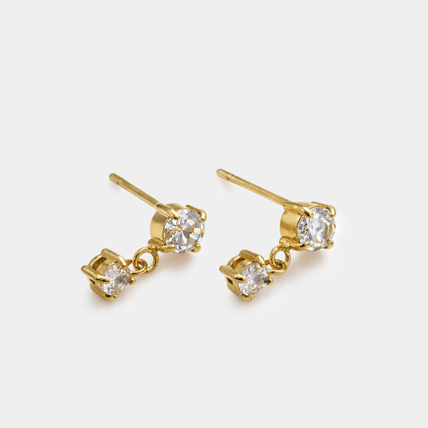 Bizou SS253E011GL – Gold stainless steel dangling earrings with two prong-set CZ stones, post closure, angled view, Bizou jewelry
