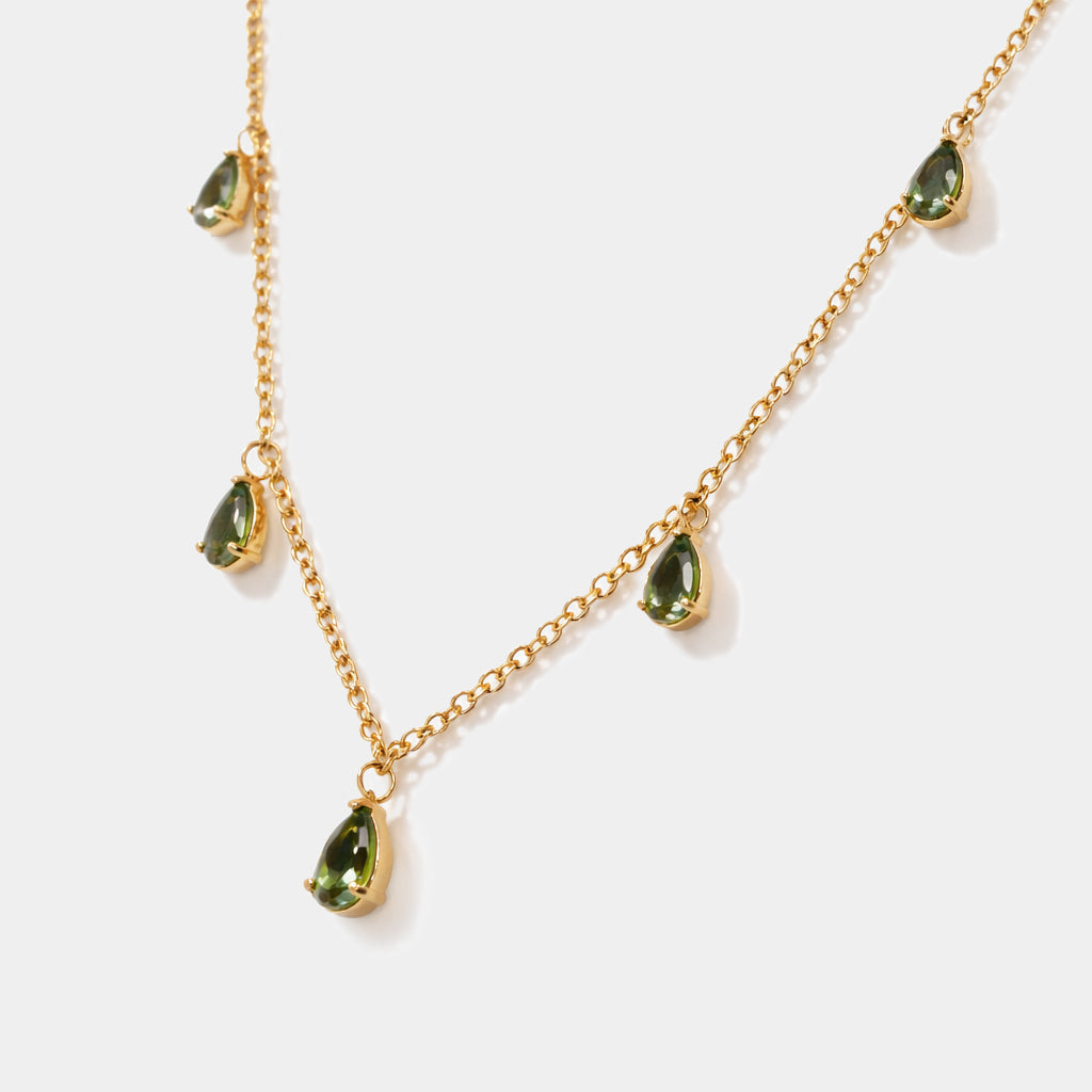 Bizou SS253N015GL – Close-up of gold stainless steel necklace with five prong-set green pear-cut stone charms, emerald green color, Bizou jewelry