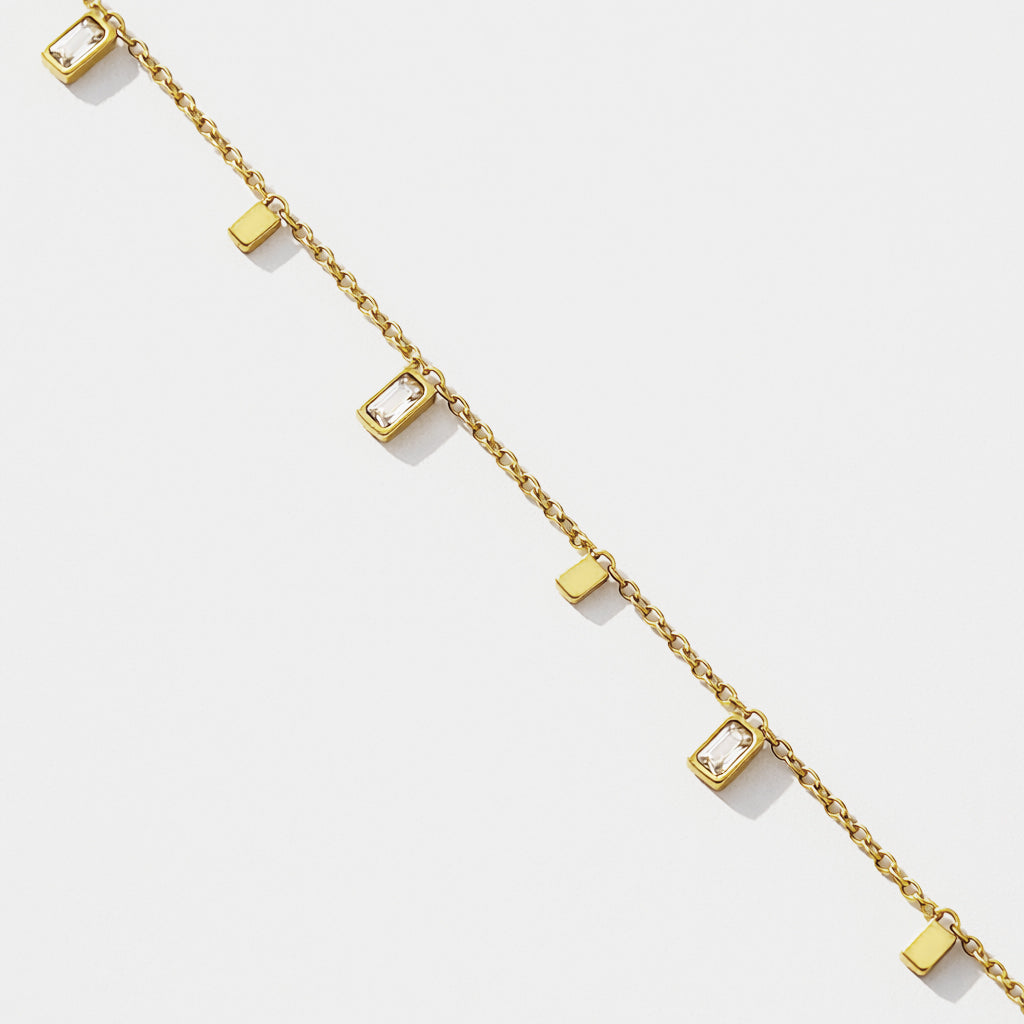 Gold stainless steel charm bracelet with rectangular cubic zirconia pendants – close-up – Bizou