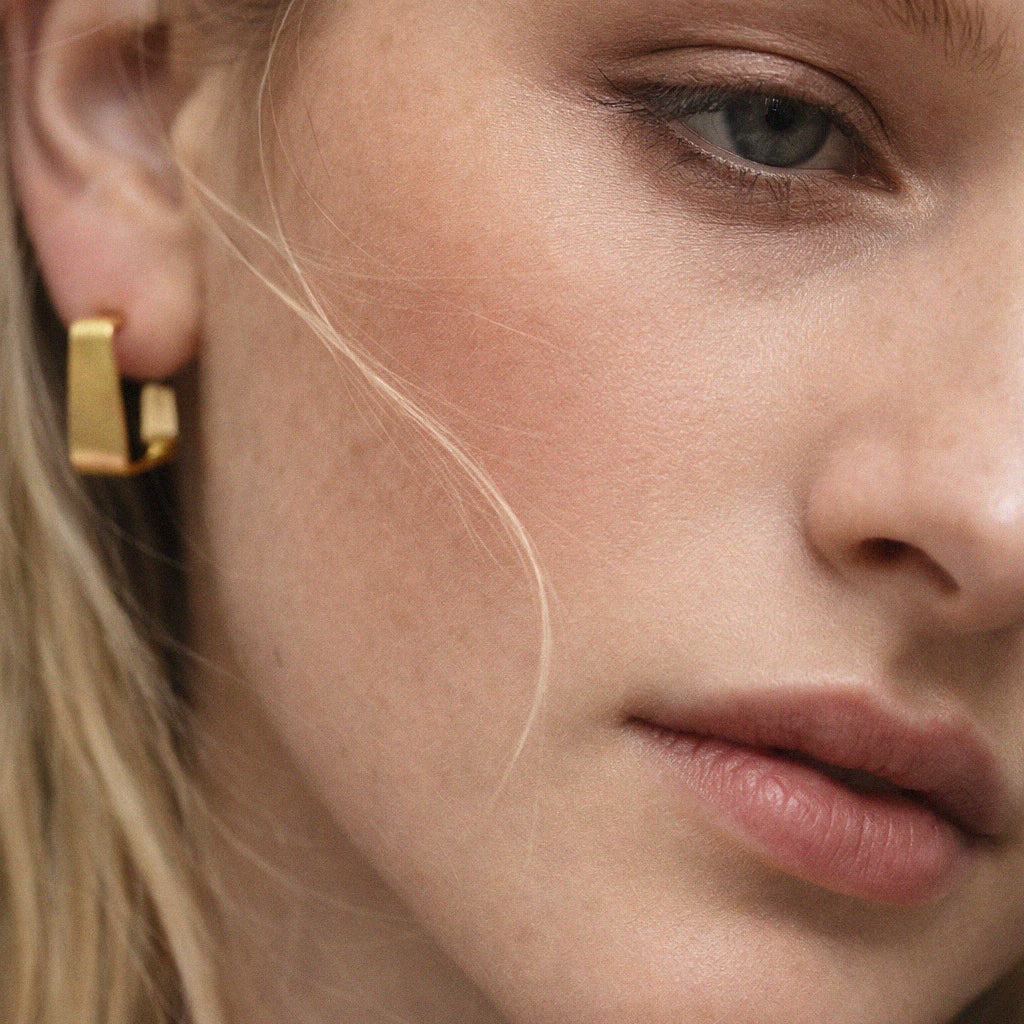 Stainless steel gold square hoop earring worn on model – Bizou jewelry