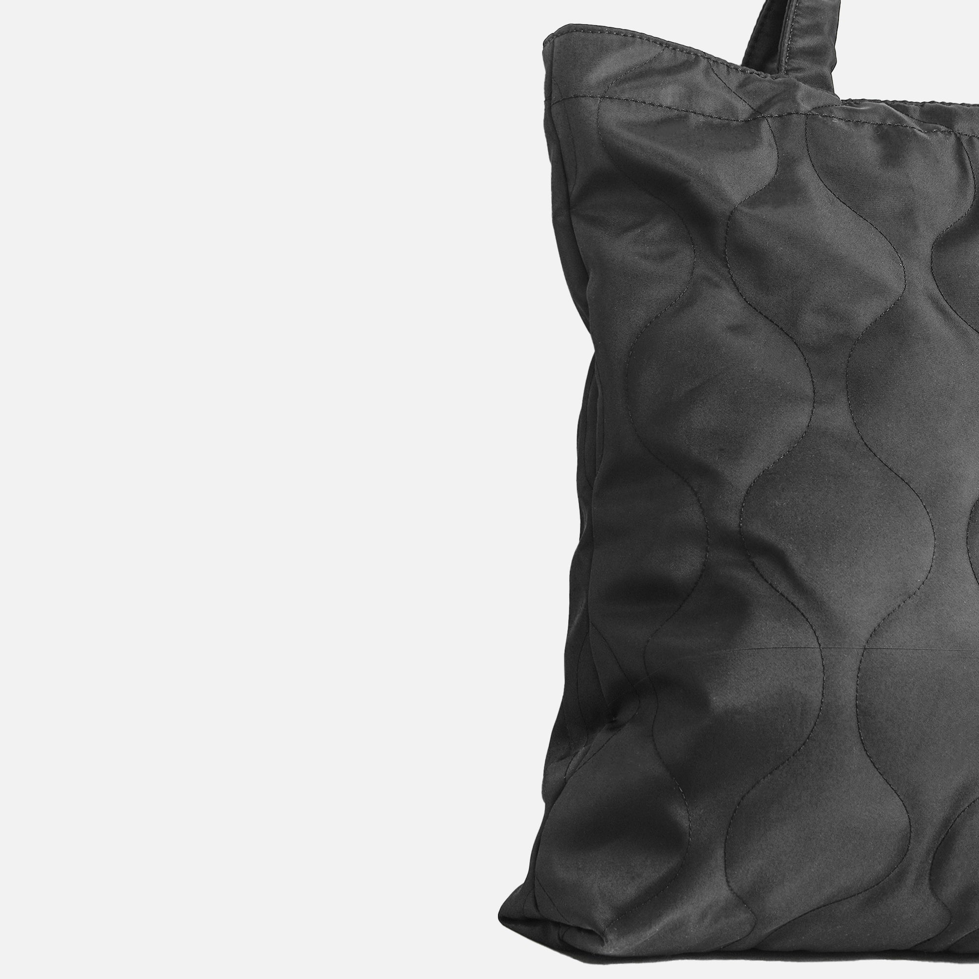 Black quilted tote handbag