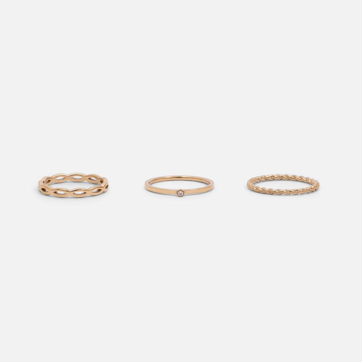 Set of three golden stainless steel wave, twist and zirconium rings
