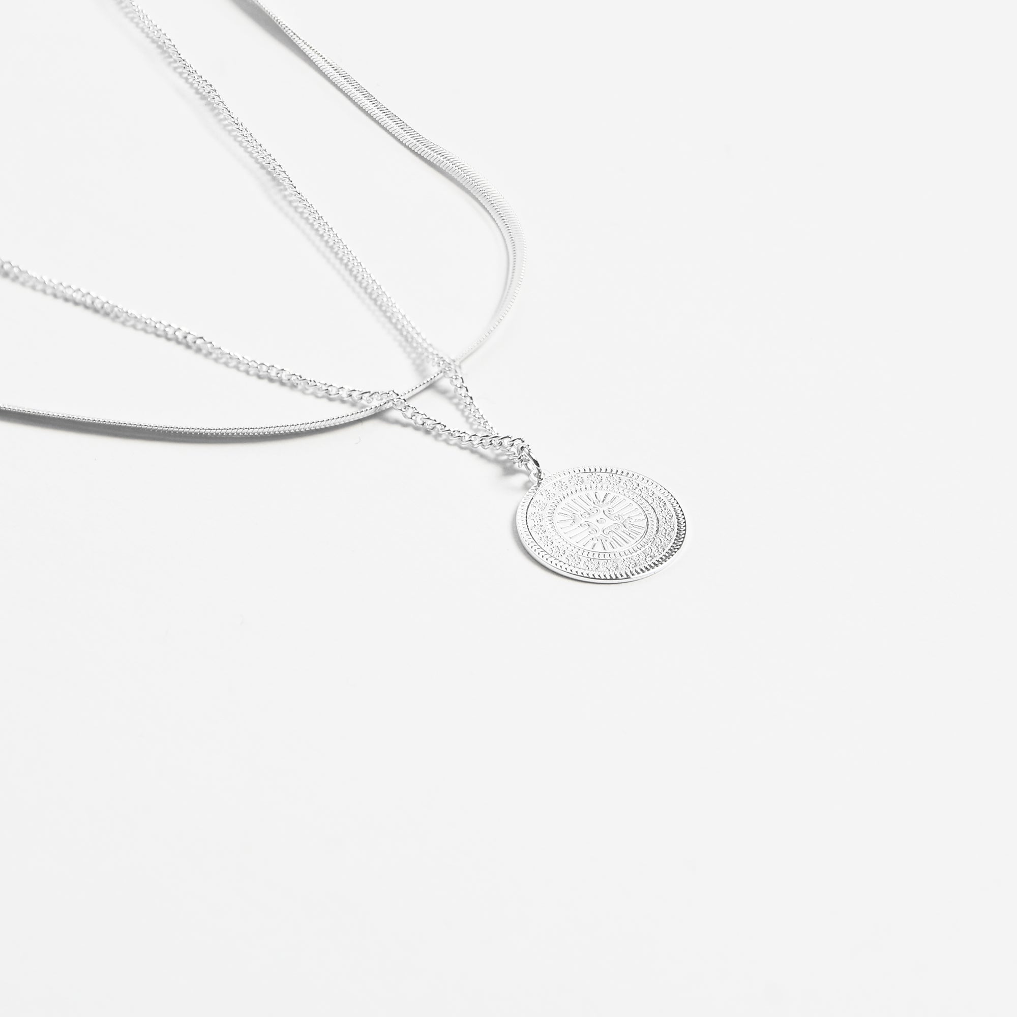 Stainless steel pendant with medallion