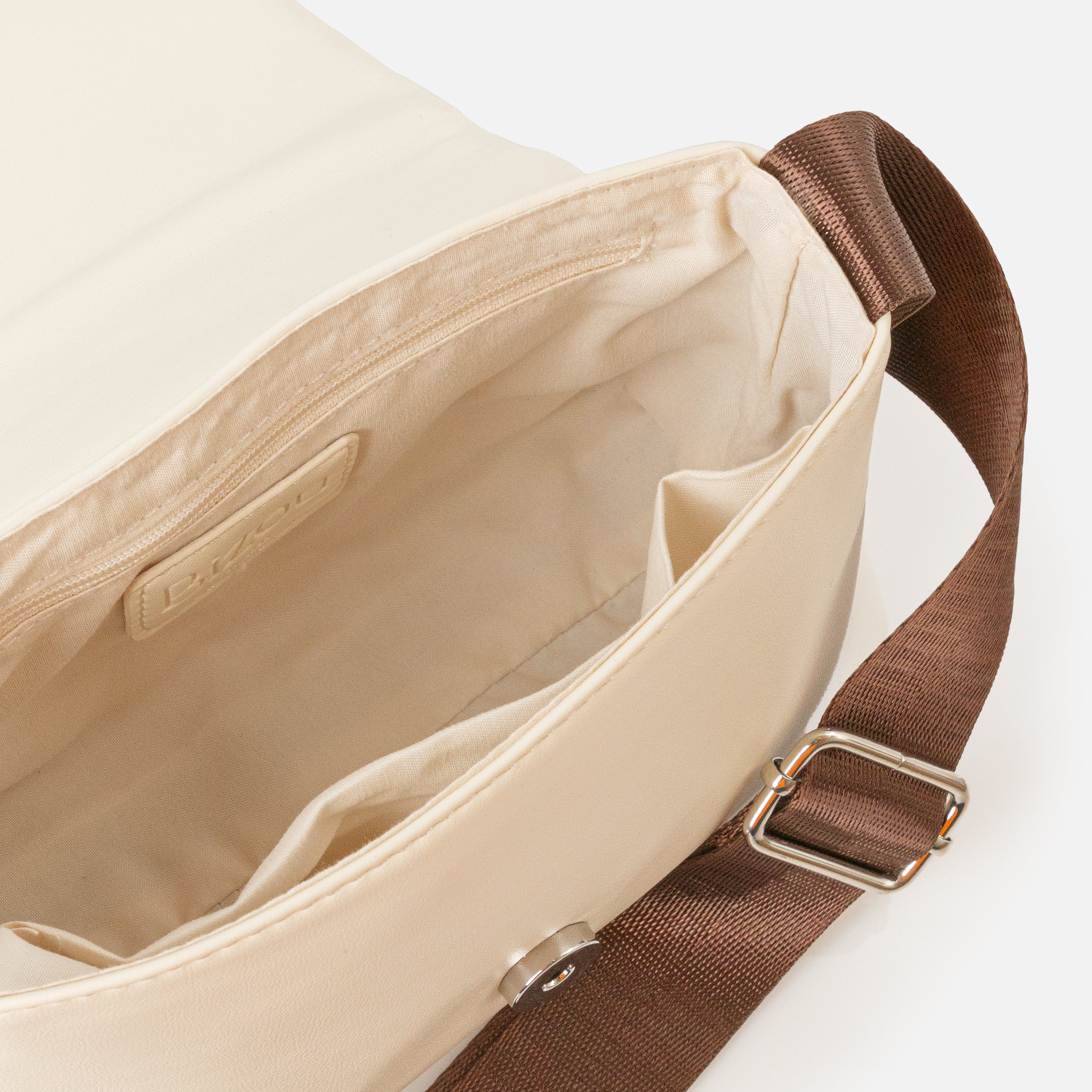 Ivory shoulder bag with quilted flap and chocolate brown braid