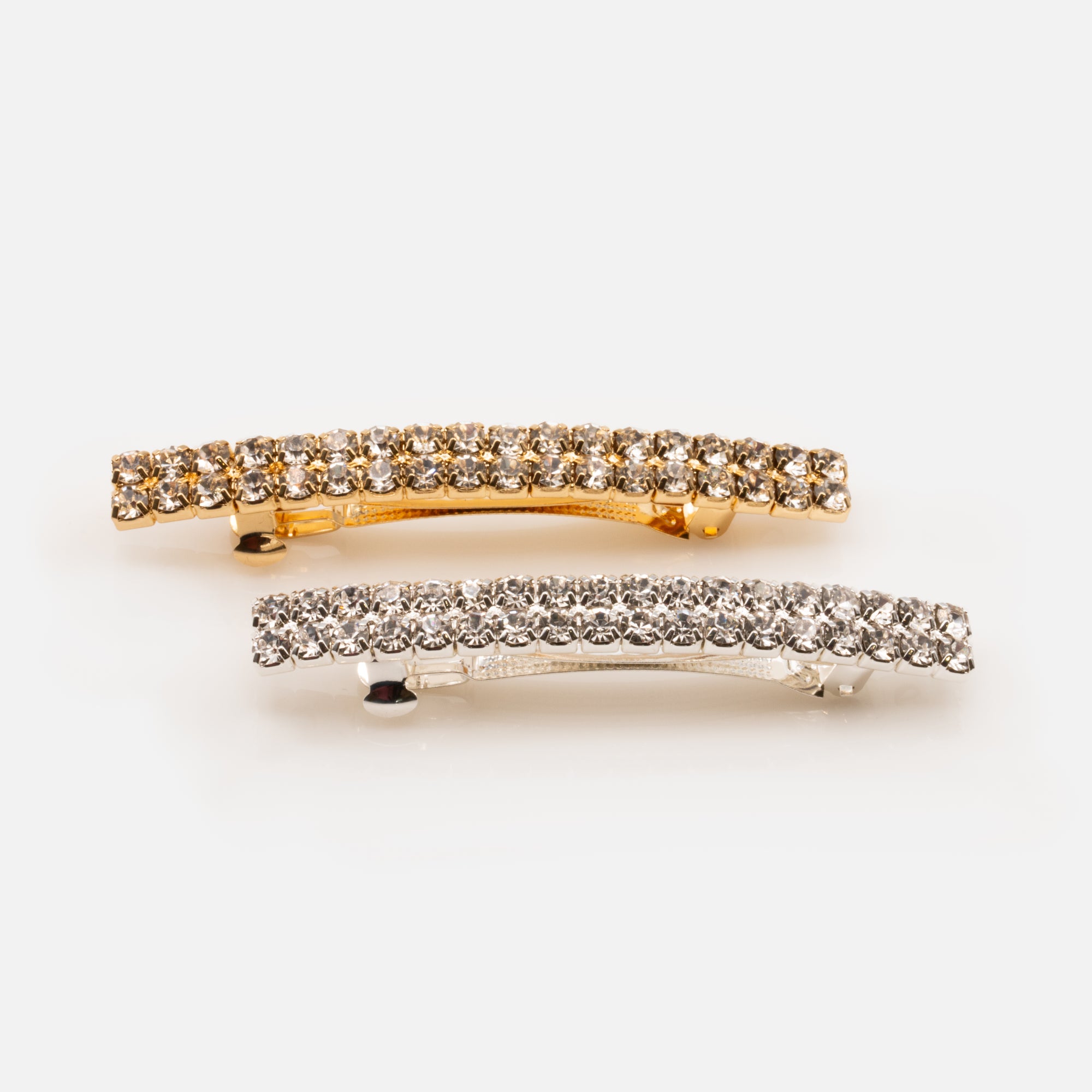 Duo of gold and silver barrettes with stones