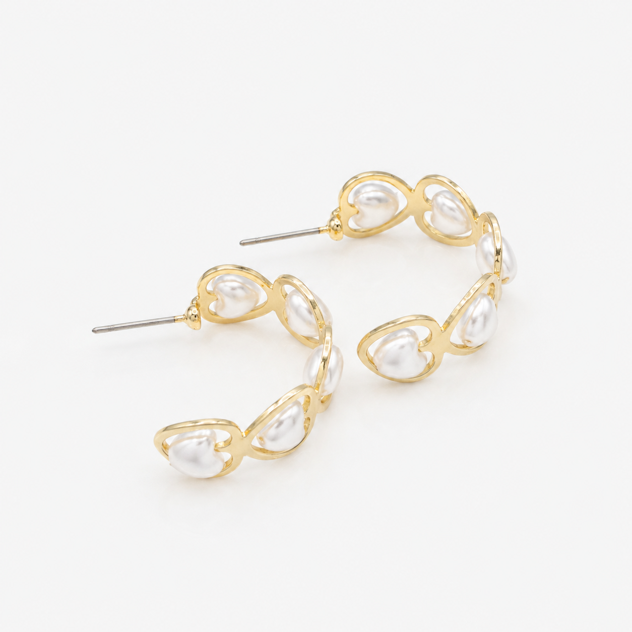 Gold half-circle earrings with heart-shaped pearls