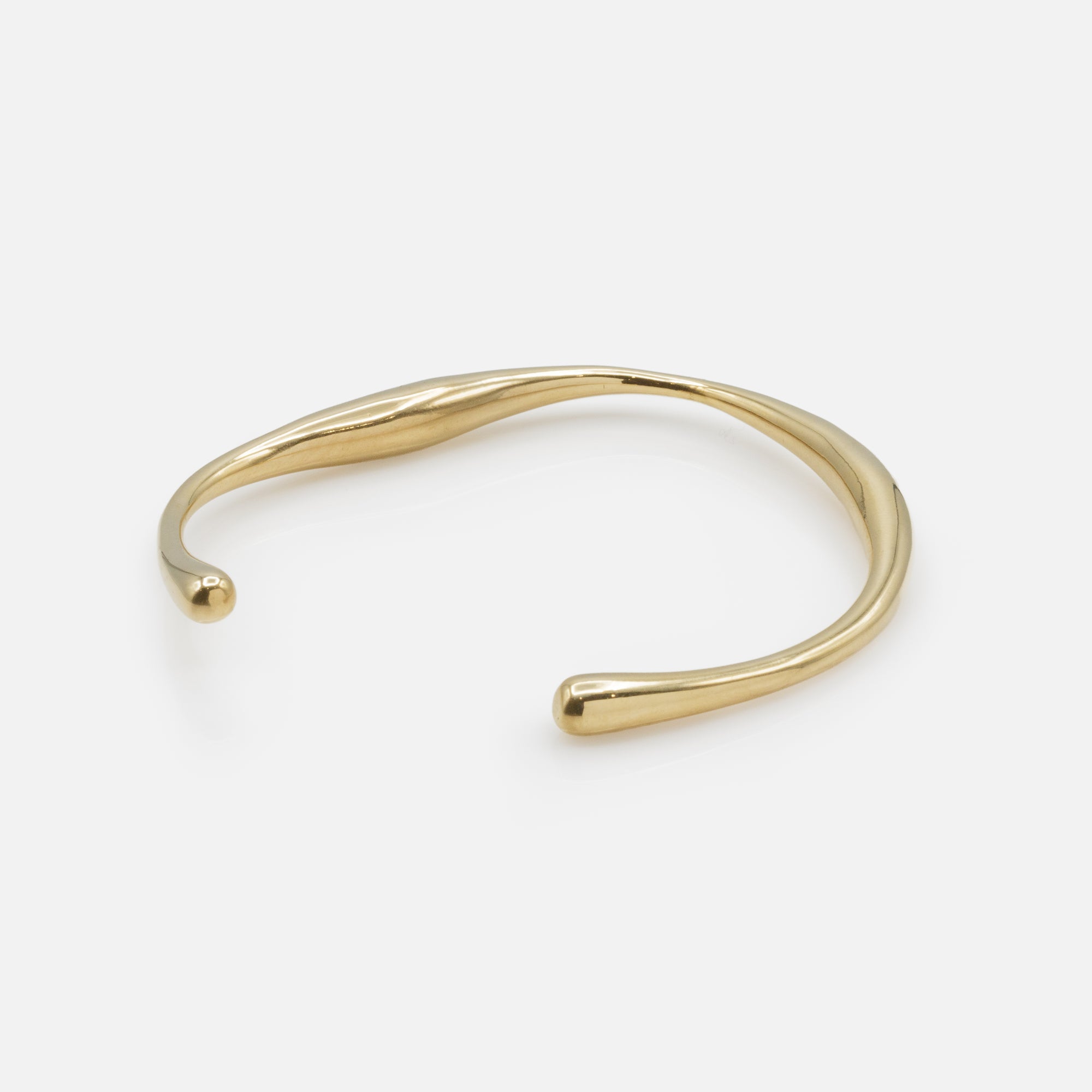 Rigid gold bracelet with irregular outline