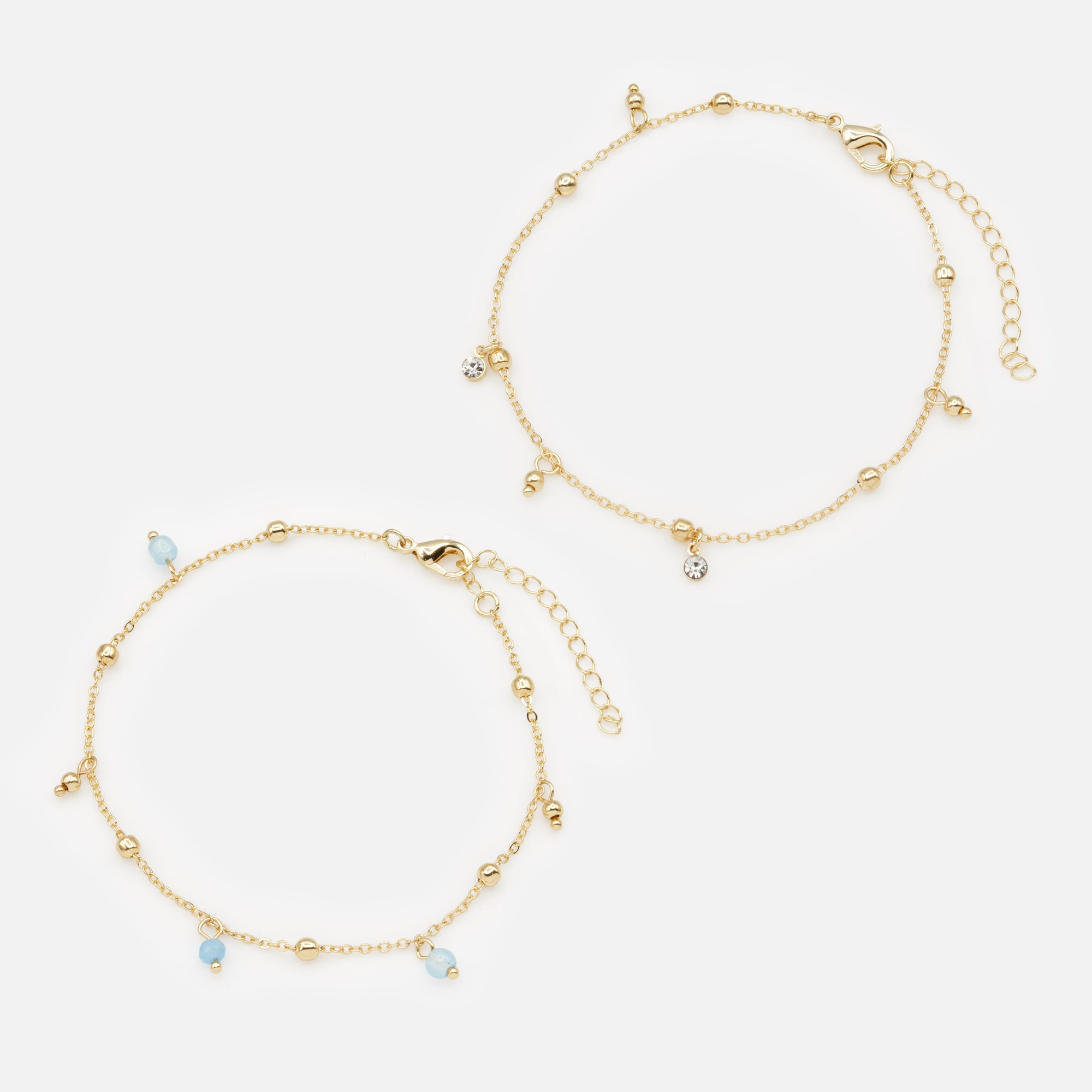 Pair of gold ankle chains with blue beads