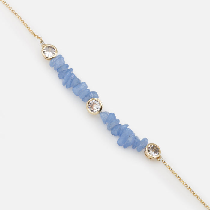 Gold bracelet with small blue stones