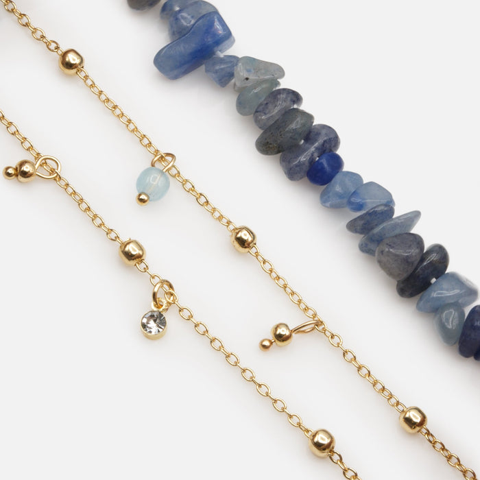 Trio of gold bracelets with blue stones and beads